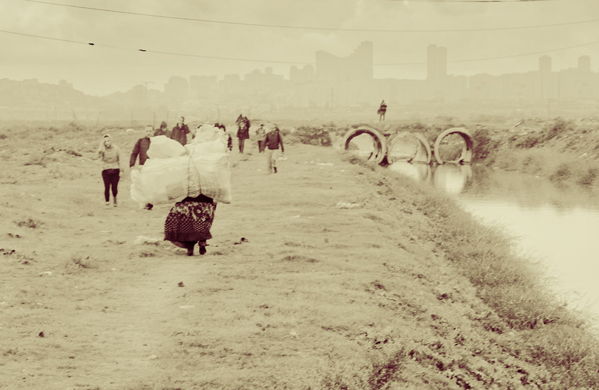 between Istanbul University's veterinary farm and the agricultural faculty: after crossing the pipe-bridge, looking north along the Hadımdere towards Bahçeşehir; a woman is carrying a large load
