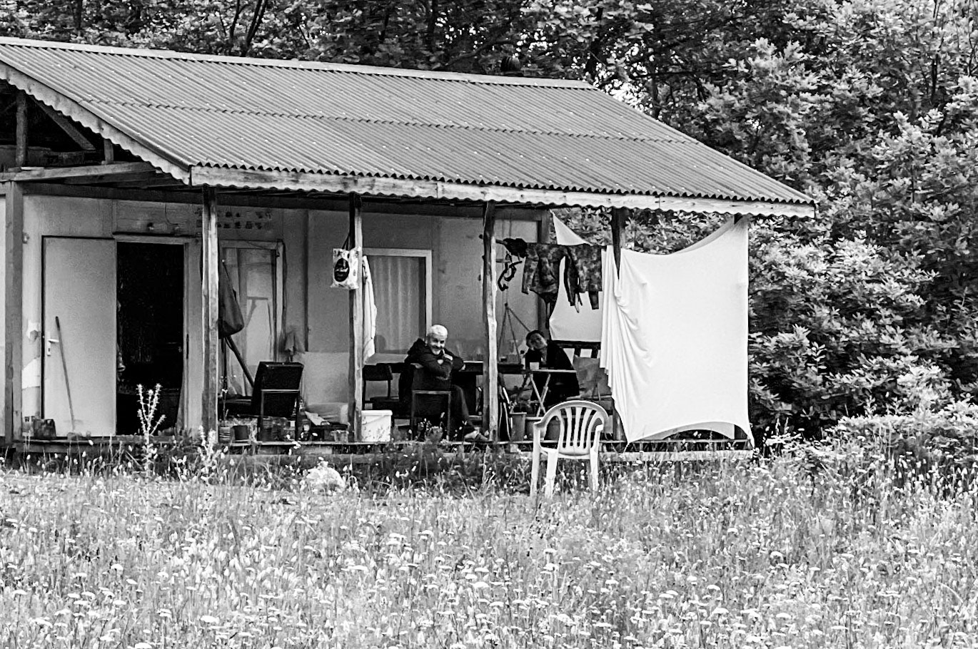 Riva SW forest: friendly people on their cottage porch