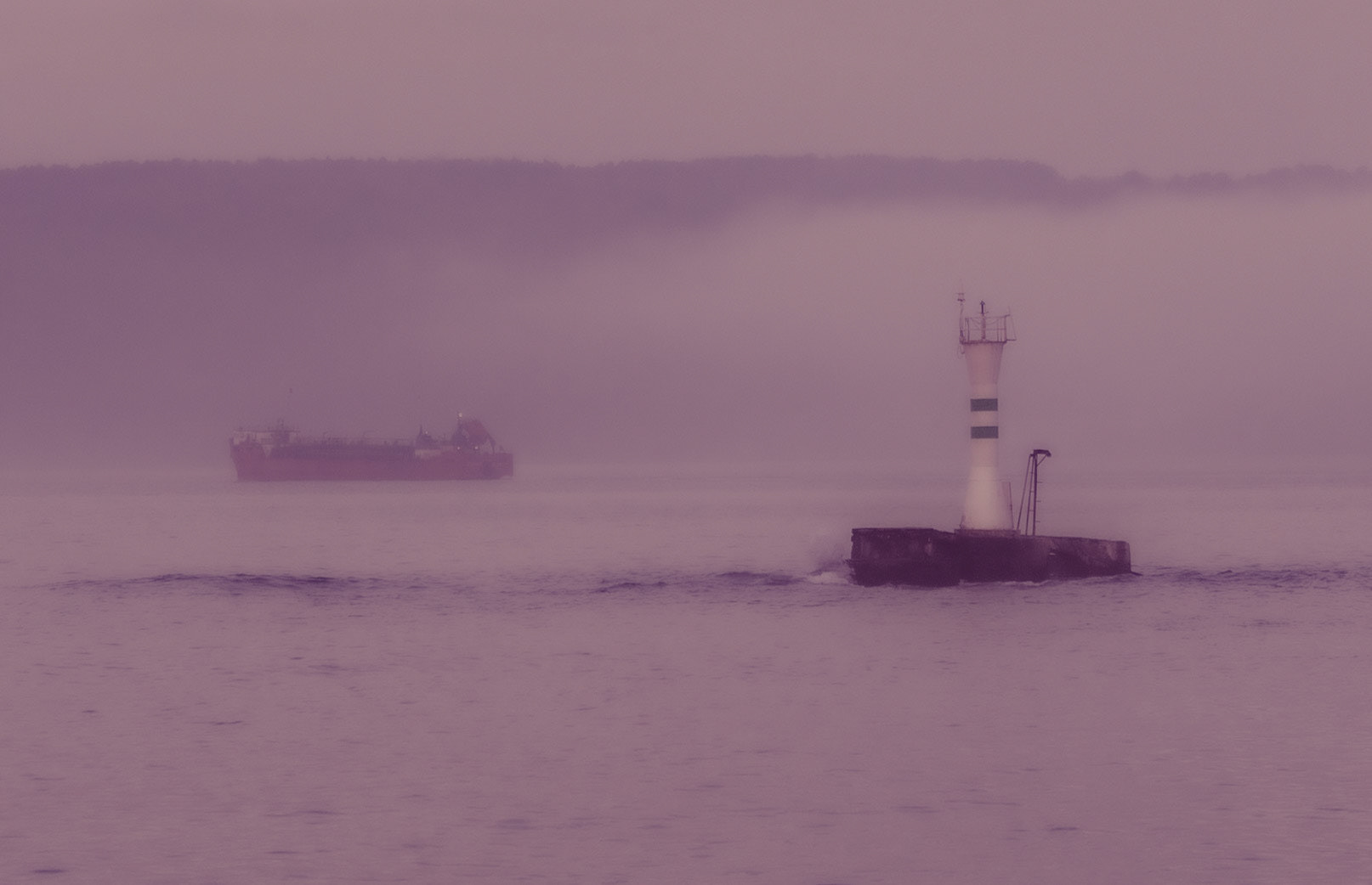 on the ferry between Anadolu Kavaǧı and Yeniköy: red ship and lighthouse in the evening mist