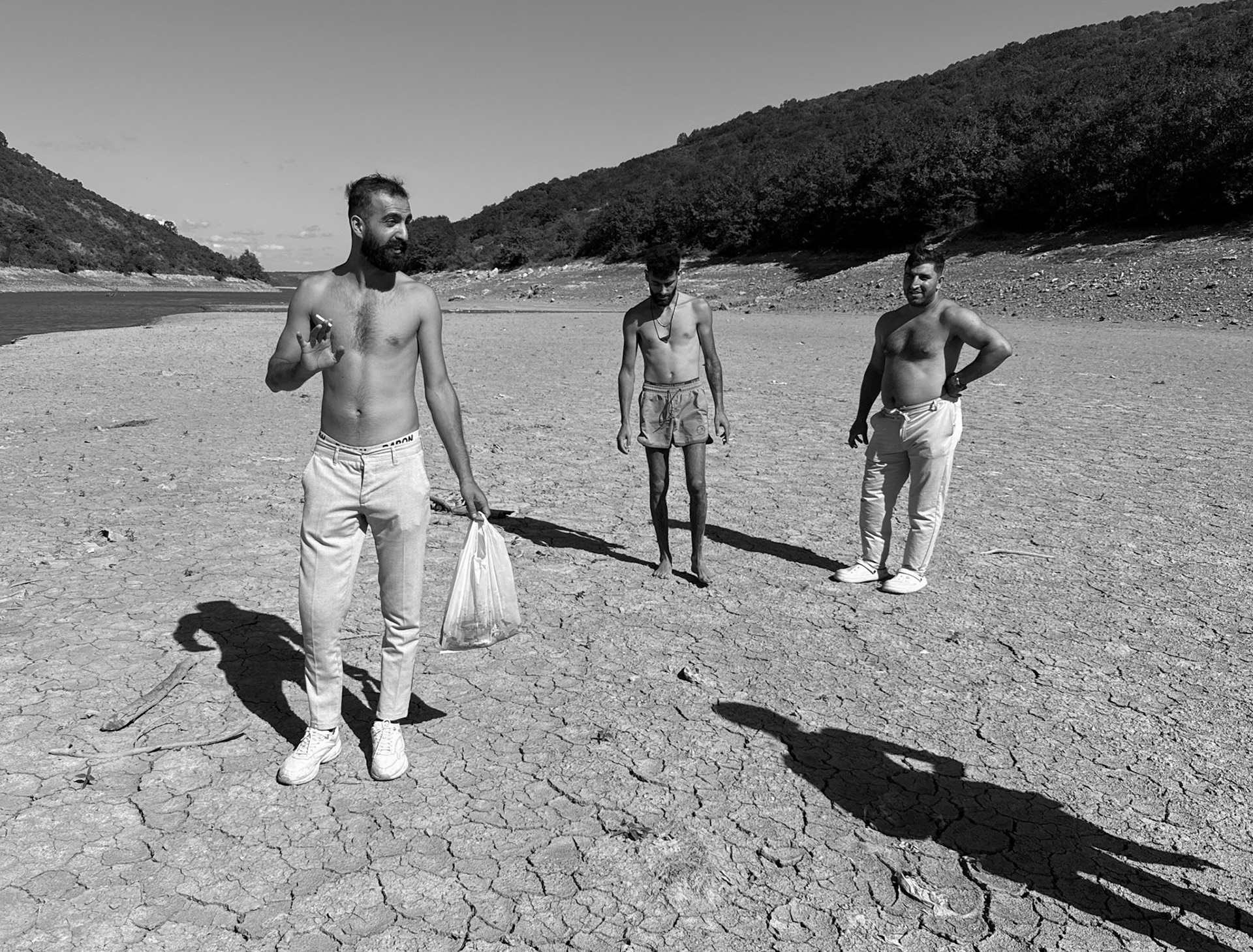 Paşaköy gorge: three lightly-dressed young men with a bag of fish