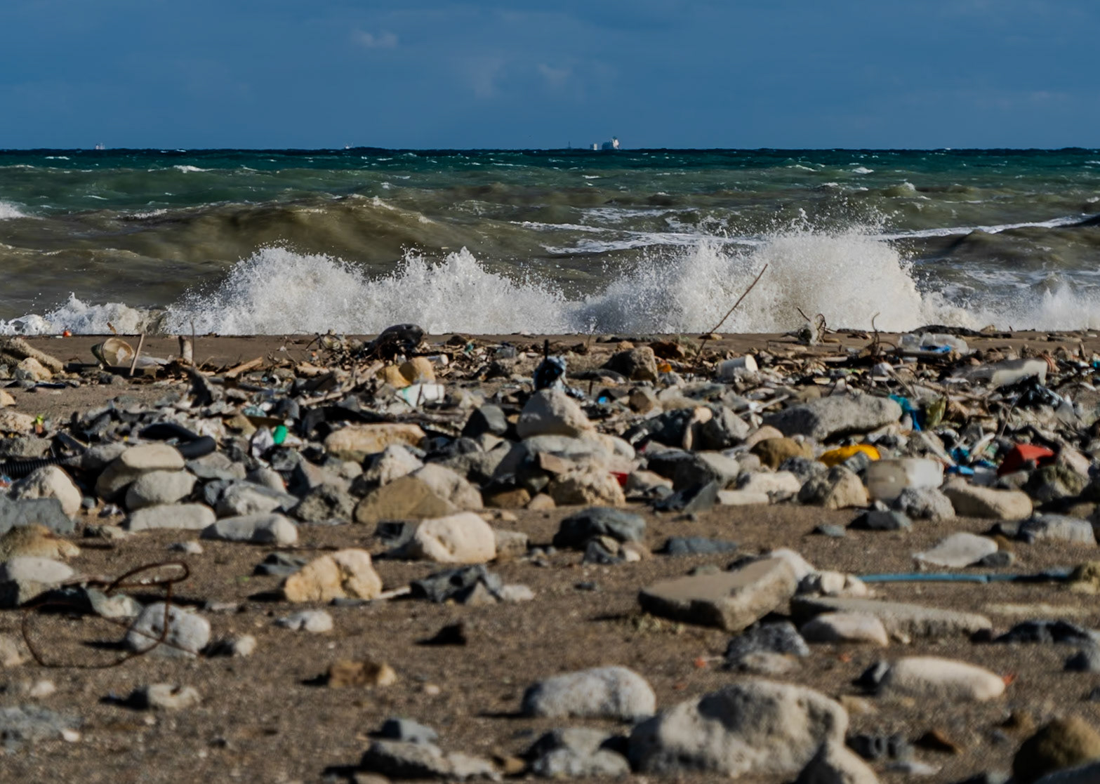 Black Sea coast east of Yeniköy: flotsam, stones, sea and a ship