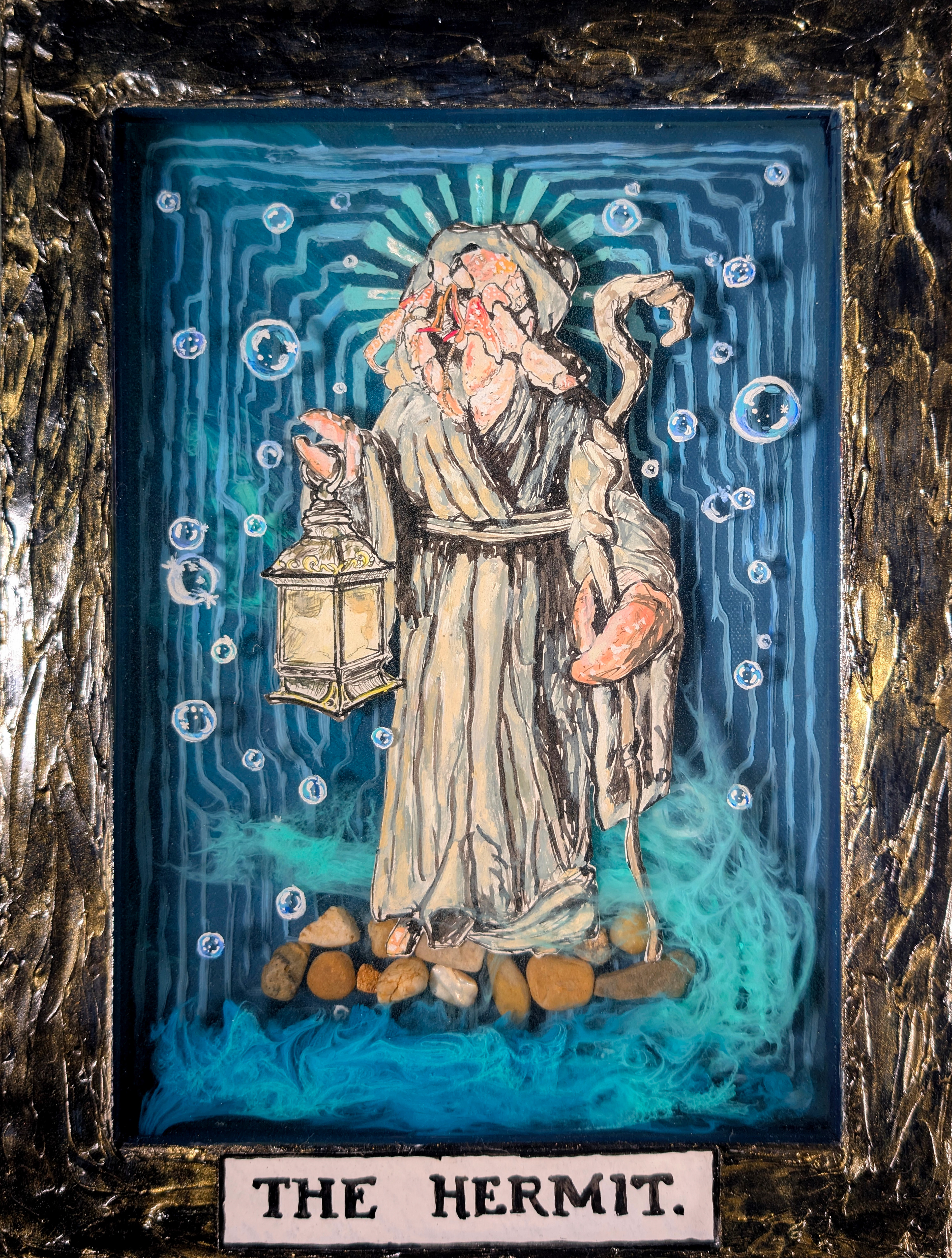 "The Hermit (crab)," 2025. Mixed media (acrylic, india ink on paper, epoxy resin, pebbles, modeling paste, and gold powder on inverted canvas).
