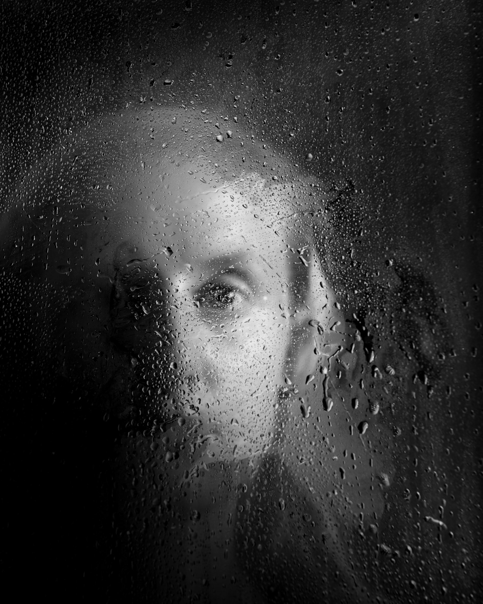 This image is part of the Immersion/ Emersion series where the human form is sometimes readily identifiable and at other times abstracted to obscurity, either evocative in its isolation or joyful in its freedom. Dylan is lit behind glass with water mist and droplets.The photo is captured in camera with minimal post processing applied.