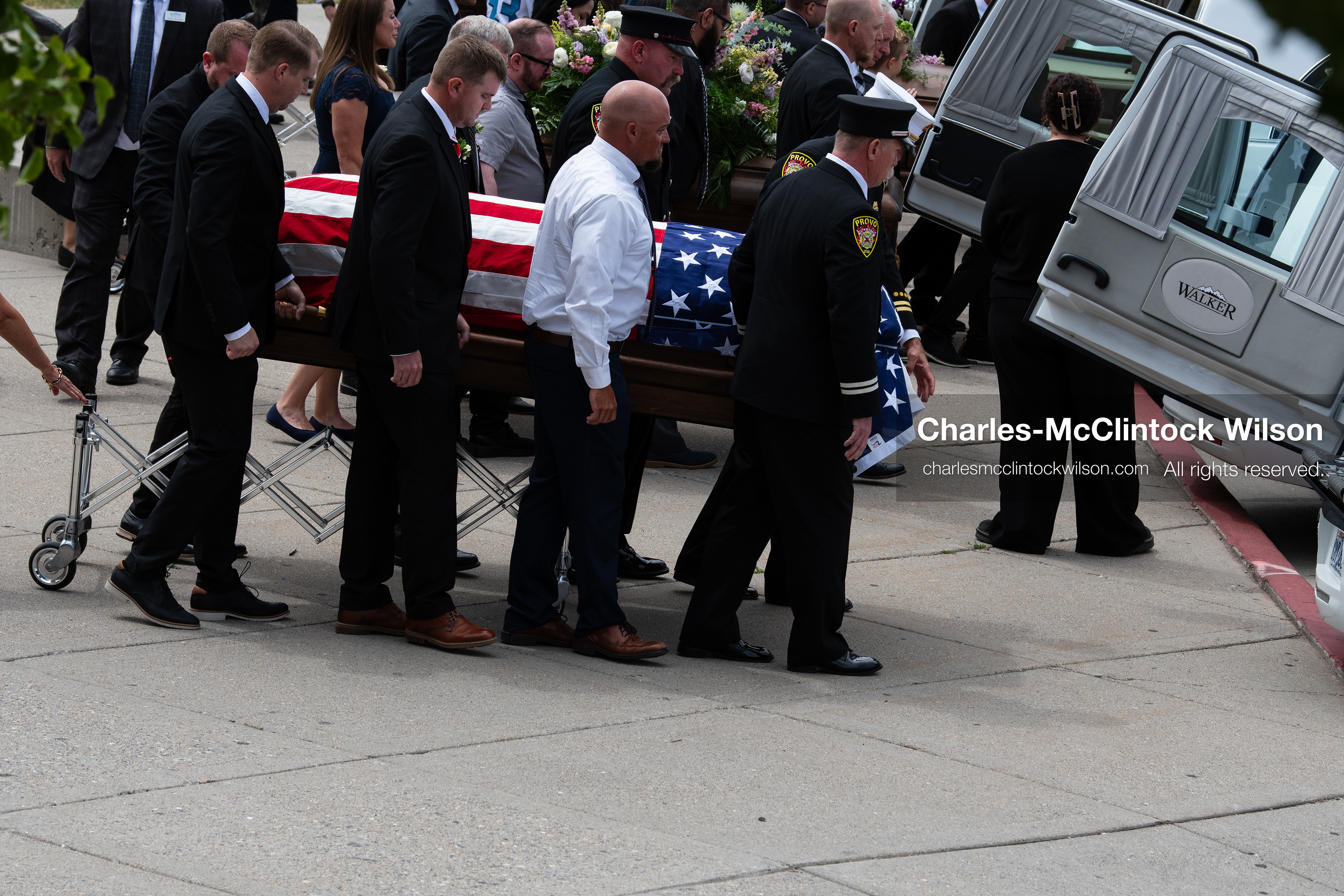 Firefighters and pallbearers load the flag-draped casket of Provo Fire Captain Spencer Long into a white hearse outside the UCCU Center at Utah Valley University in Orem, Utah, on Wednesday, July 29, 2026. More than 300 people came to the public memorial ceremony to honor Captain Long, his wife Katrina, and three of their sons, who died after a flash flood hit their campsite near the Sunglow Campground in Wayne County. (Photo by Charles-McClintock Wilson/Sipa USA)