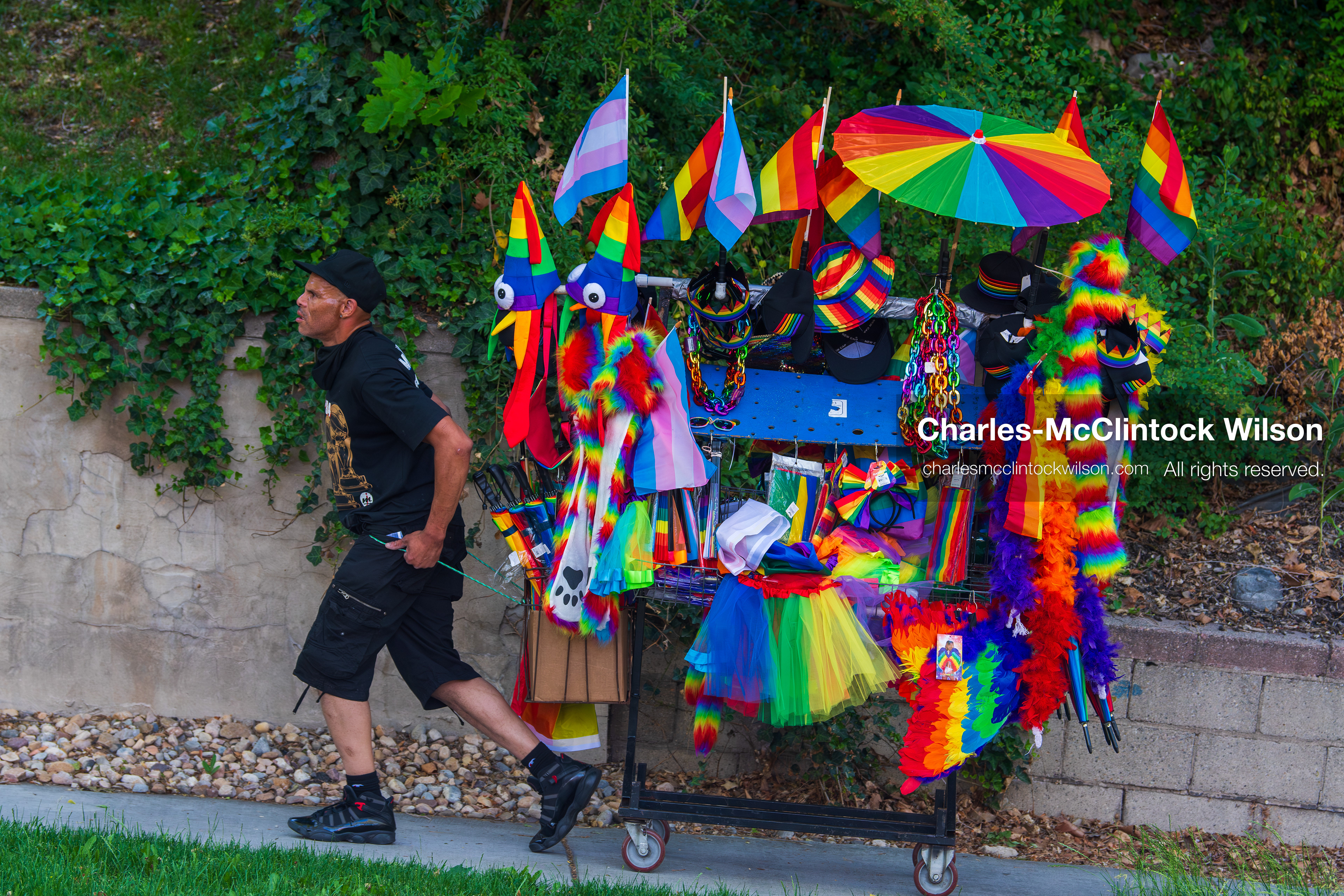 June 6, 2026, Salt Lake City, Utah, USA: A street vendor pulls a cart loaded with rainbow flags, hats, and colorful merchandise during the Utah Pride Rally and March. (Credit Image: © Charles-McClintock Wilson/ZUMA Press Wire)
