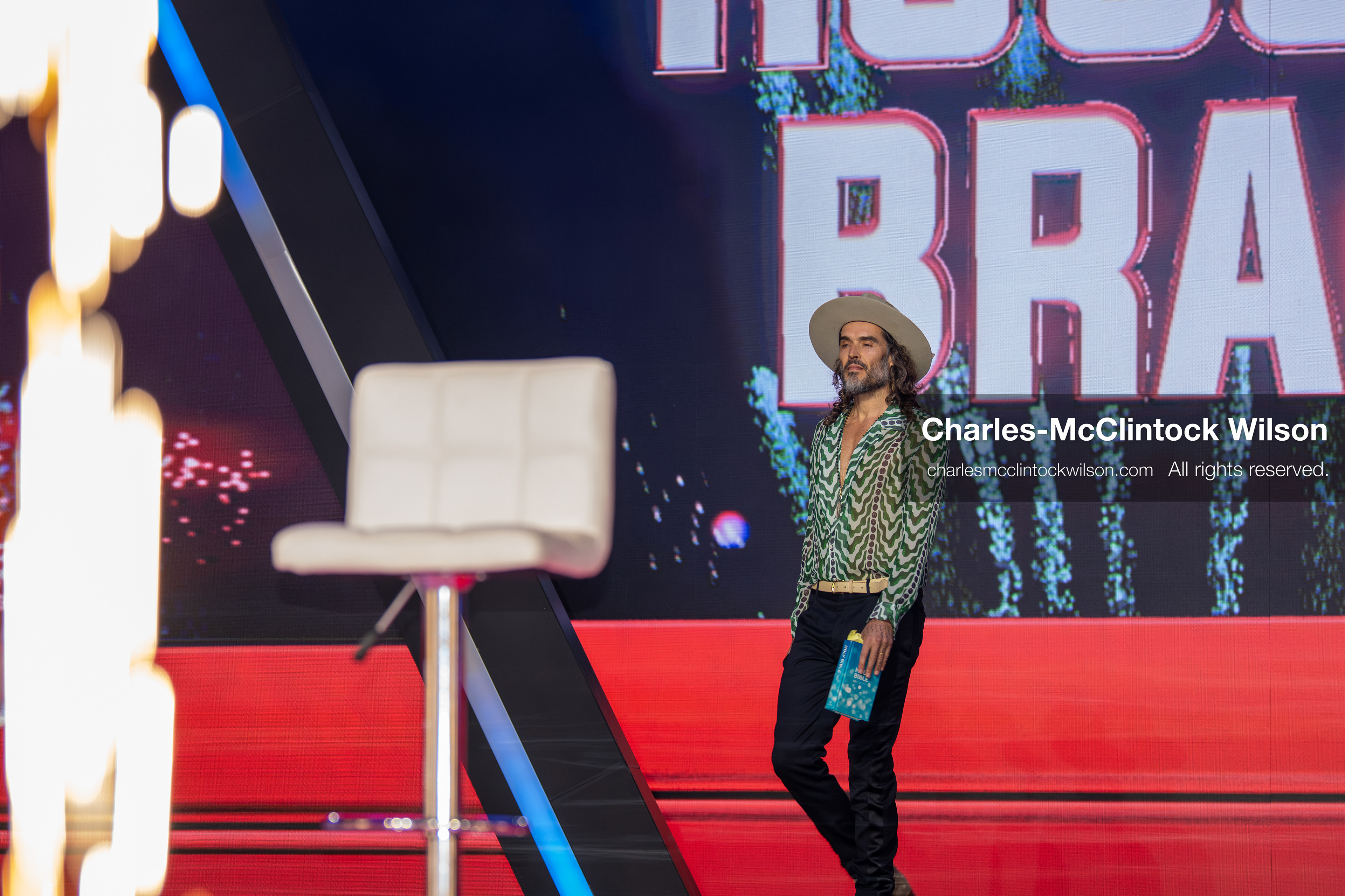 December 18, 2025, Phoenix, Arizona, USA: Russell Brand walks toward the stage during Day One of Turning Point USA’s AmericaFest 2025 at the Phoenix Convention Center in Phoenix, Arizona.