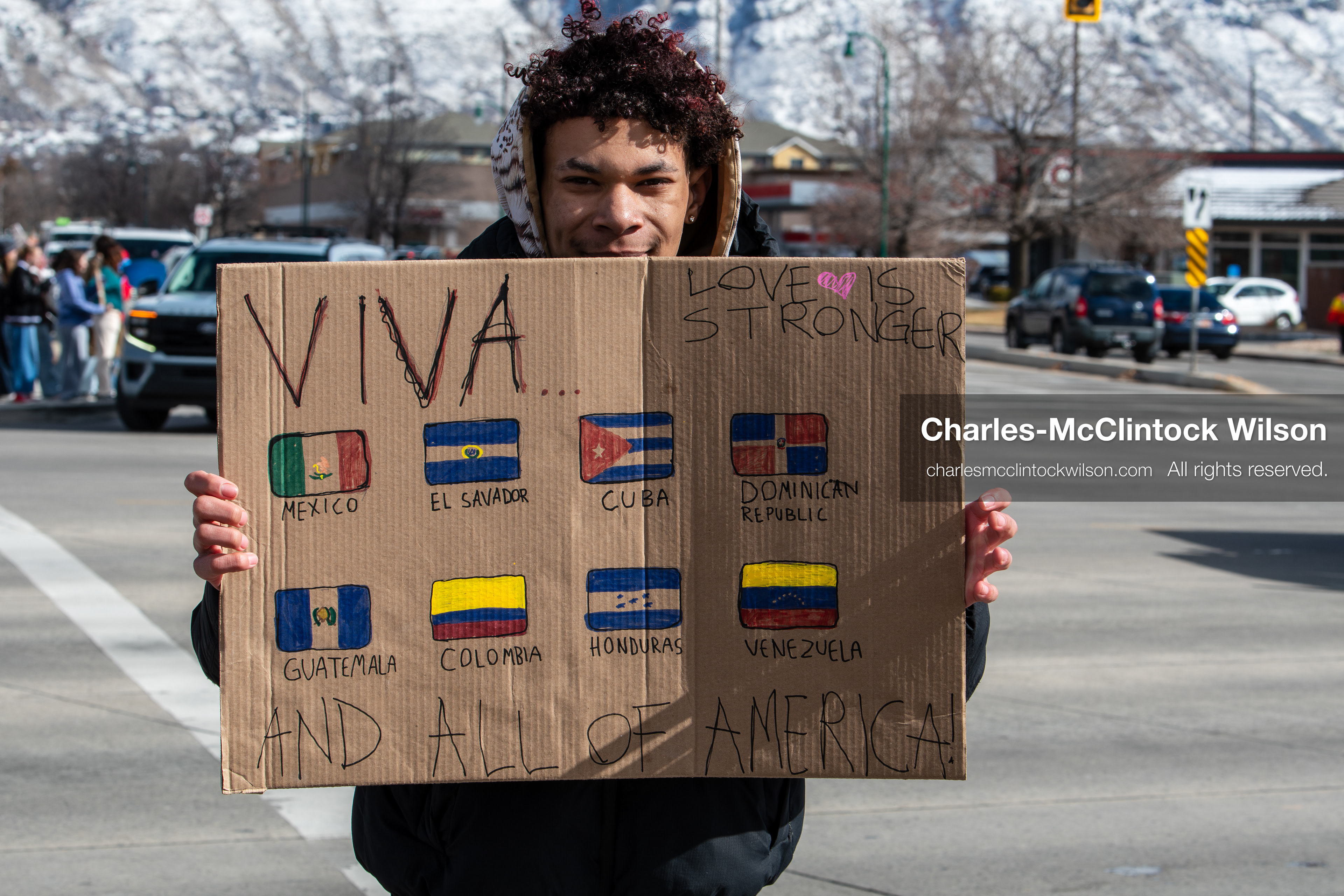 February 20, 2026, Orem, Utah, USA: A participant holds a sign displaying multiple Latin American flags during a student led protest against ICE in front of Orem City Hall. Demonstrators gathered along State Street as traffic moved through the area. (Credit Image: © Charles McClintock Wilson/ZUMA Press Wire)