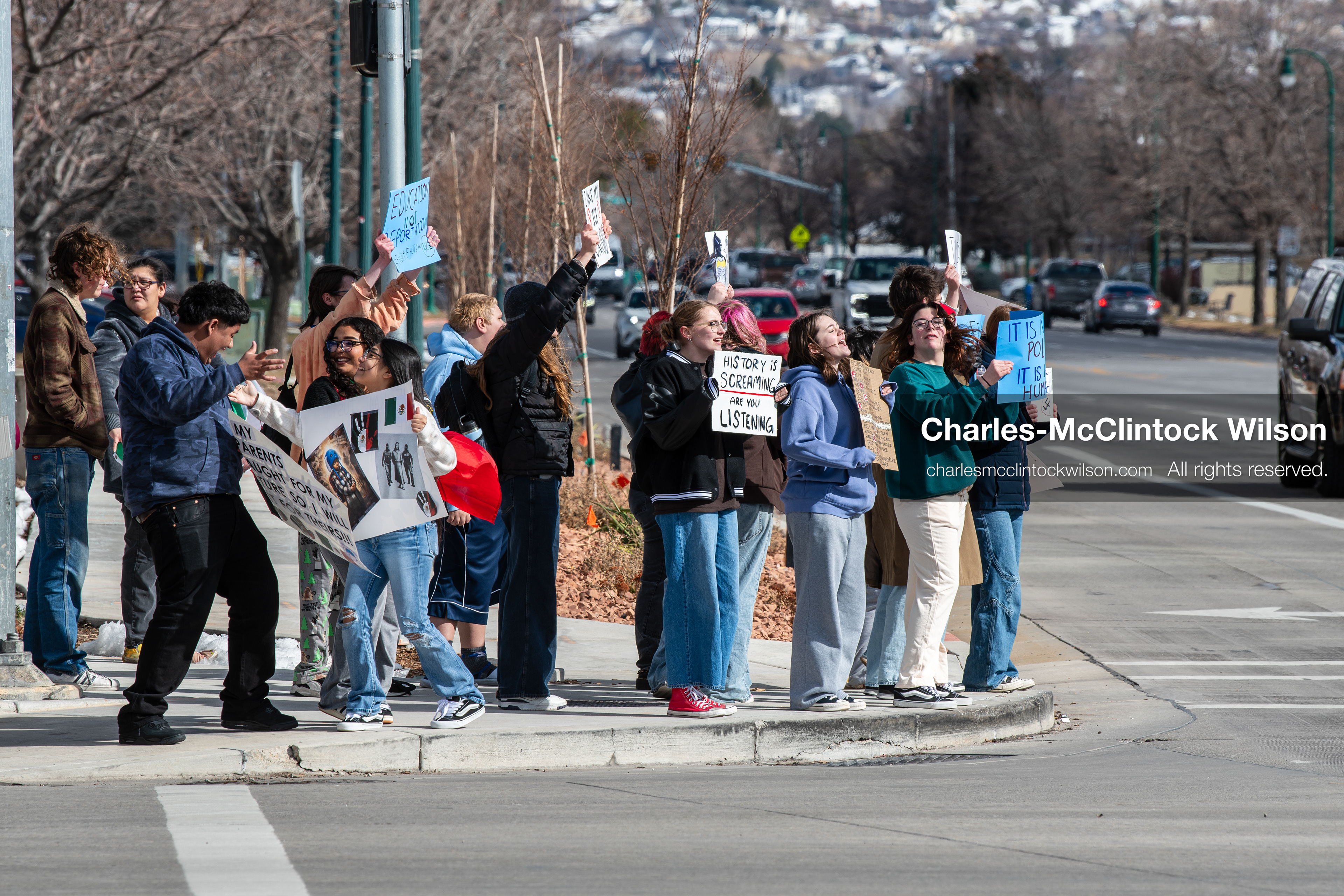 February 20, 2026, Orem, Utah, USA: High school students gather along State Street in front of Orem City Hall during a student led protest against ICE and federal immigration enforcement. Demonstrators hold signs as they stand near the roadway while traffic continues through the area. (Credit Image: © Charles McClintock Wilson/ZUMA Press Wire)