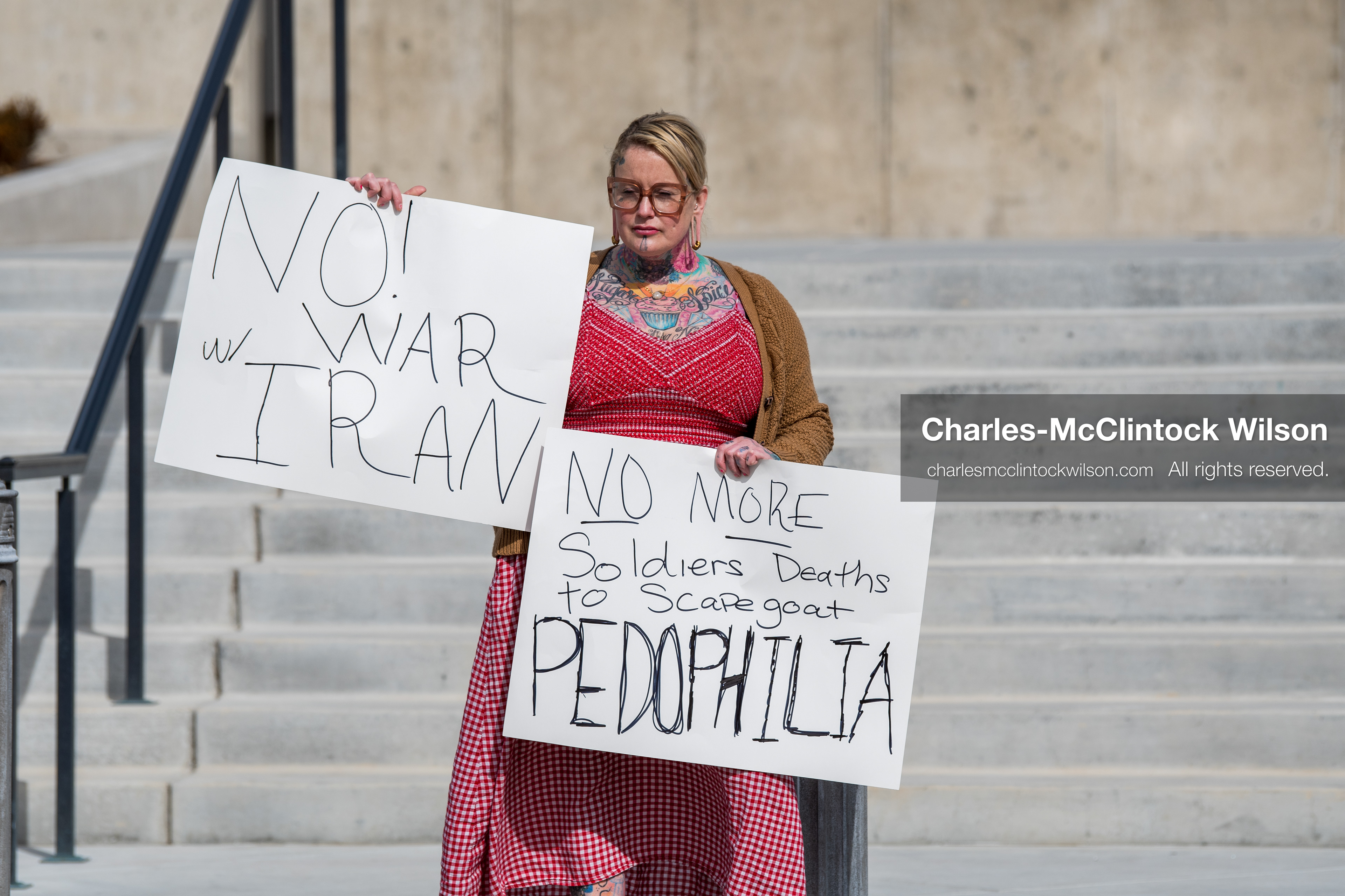 February 28, 2026, Salt Lake City, Utah, USA: A demonstrator stands on the steps of the Utah State Capitol holding two handwritten protest signs during the Stand With Ukraine rally. The gathering marked the four year anniversary of the full scale Russian invasion of Ukraine and brought community members together in support of Ukrainians and local humanitarian efforts. (Credit Image: © Charles McClintock Wilson/ZUMA Press Wire)