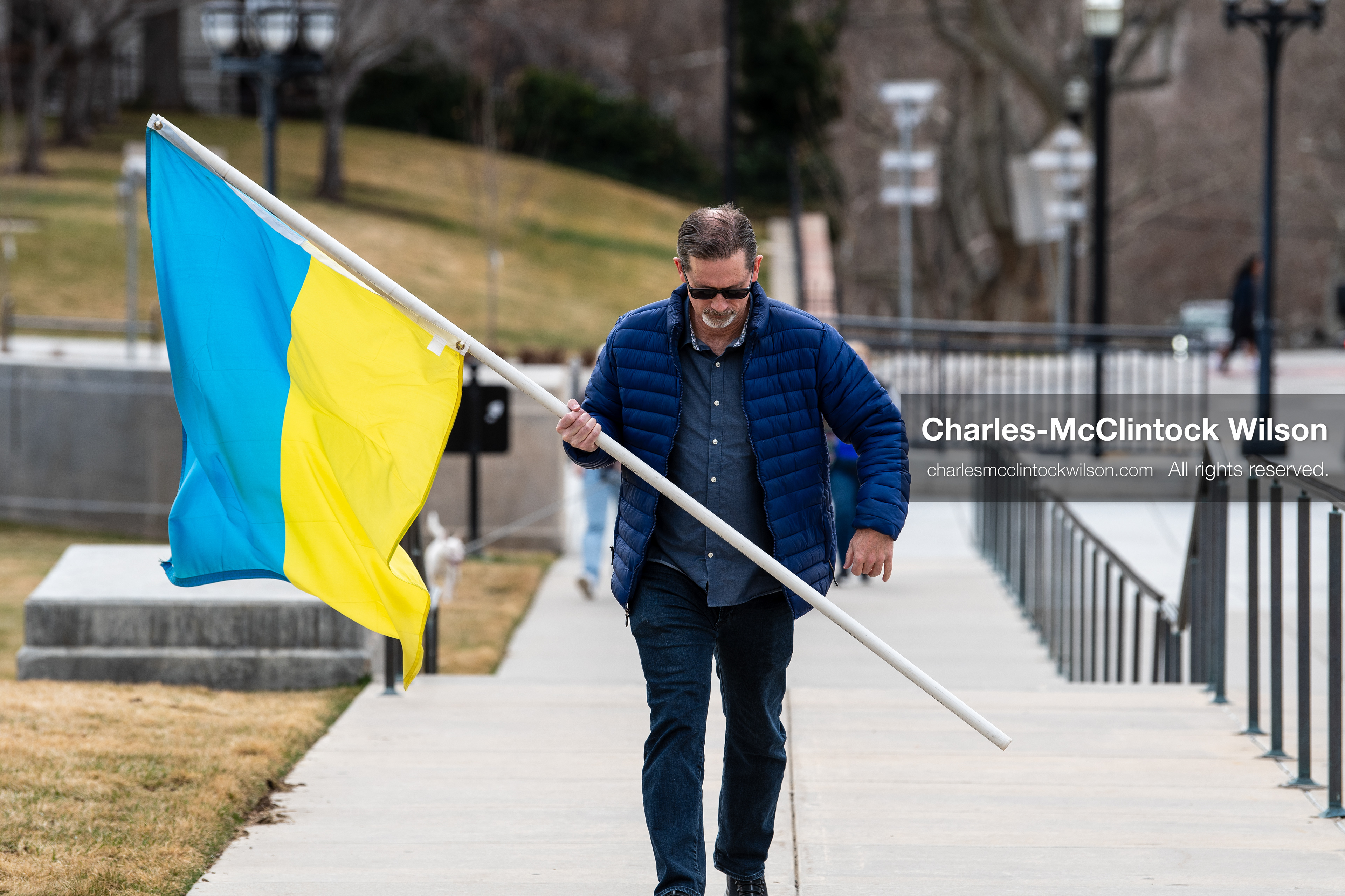 February 28, 2026, Salt Lake City, Utah, USA: JOHN BOYD, a Utah Forward Party candidate for Utah House District 53, carries a large Ukrainian flag while walking near the Utah State Capitol during the Stand With Ukraine rally. The gathering marked the four year anniversary of the full scale Russian invasion of Ukraine and brought community members together in support of Ukrainians and local humanitarian efforts. (Credit Image: © Charles McClintock Wilson/ZUMA Press Wire)