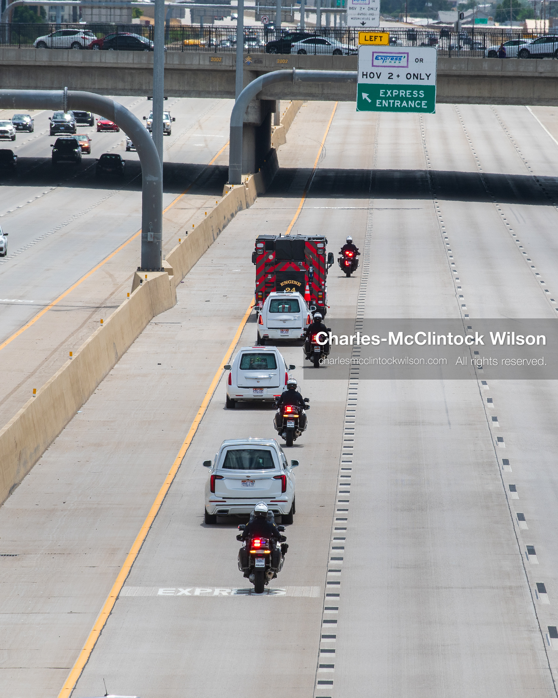 A motorcade of white hearses travels down Interstate 15 during a funeral procession for Provo Fire Captain Spencer Long and his family in Orem, Utah, on Wednesday, July 29, 2026. More than 300 people came to the public memorial ceremony to honor the five family members who died after a flash flood hit their campsite near the Sunglow Campground in Wayne County. (Photo by Charles-McClintock Wilson/Sipa USA)