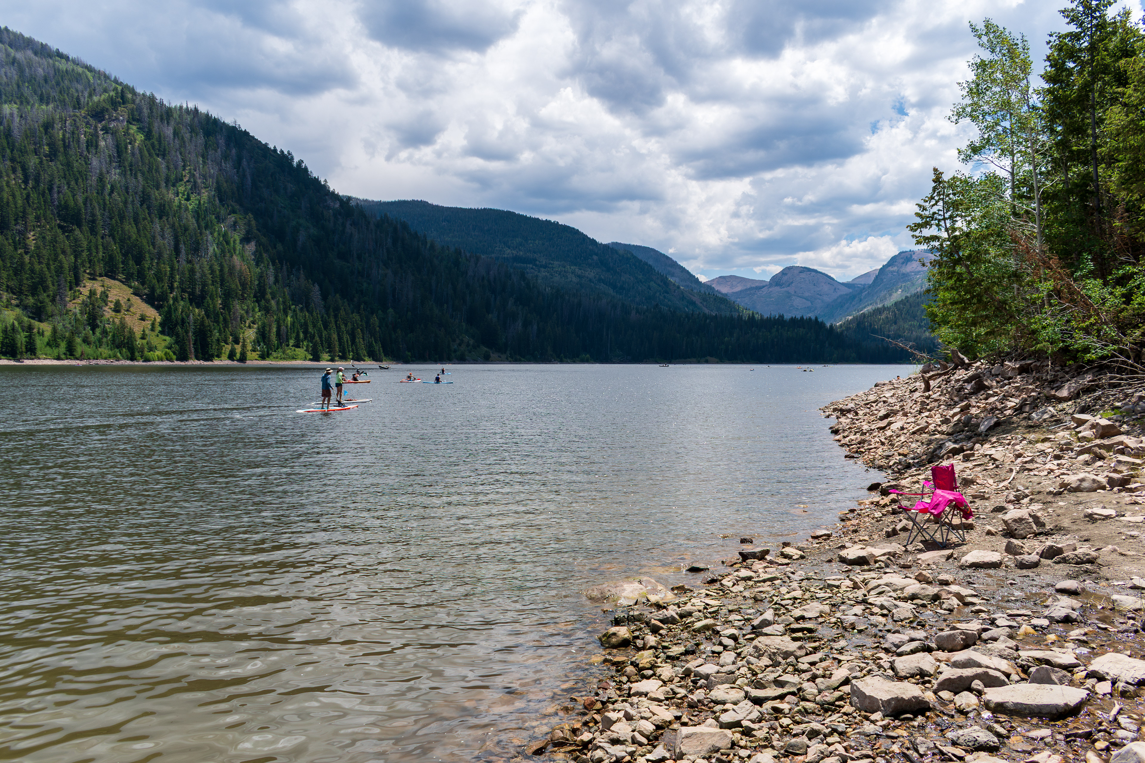 Summit County, Utah – July 20, 2025: People enjoy outdoor recreation on kayaks and paddleboards at Smith and Morehouse Reservoir.