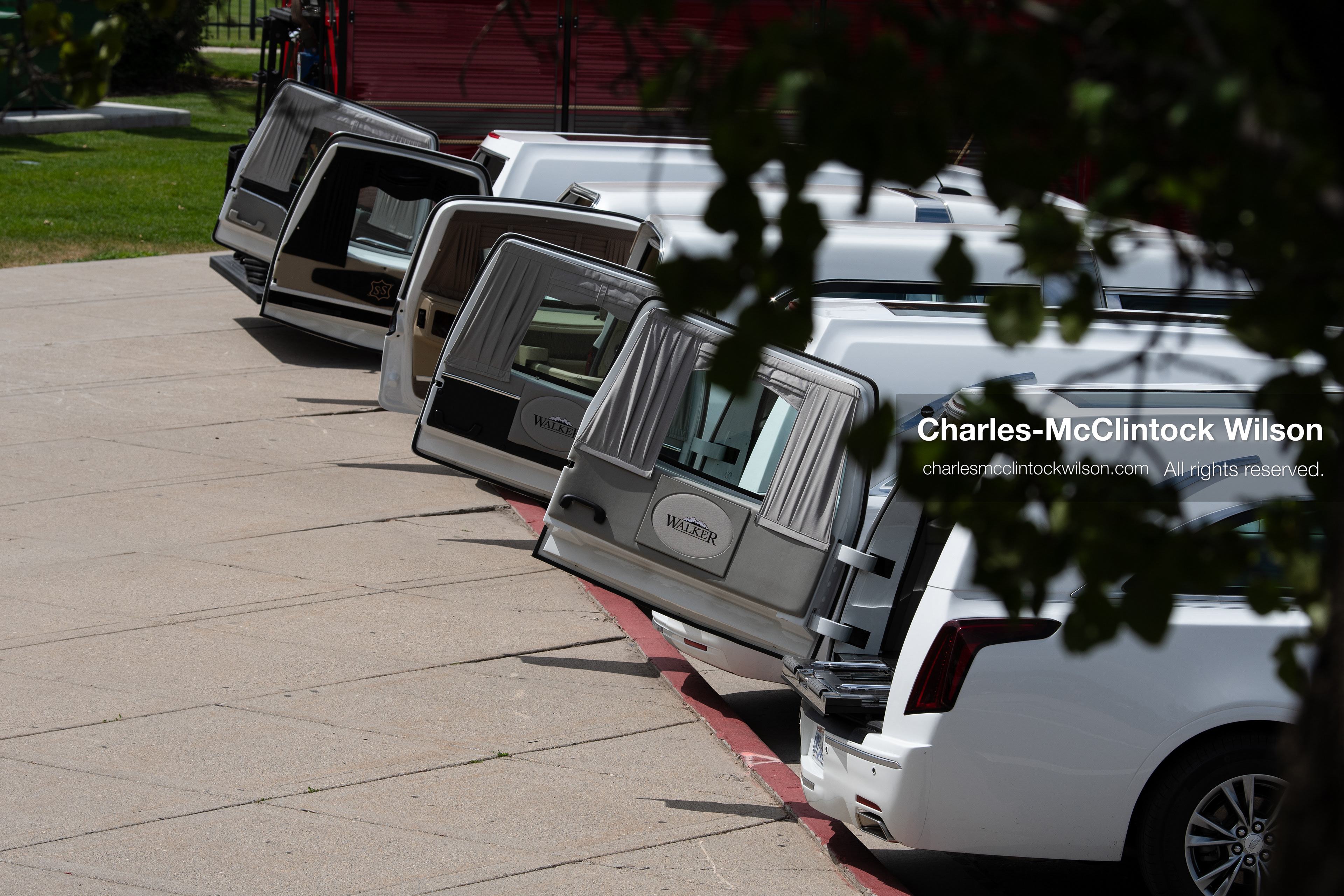 A row of white Cadillac hearses sits with back doors open outside the UCCU Center at Utah Valley University in Orem, Utah, on Wednesday, July 29, 2026. More than 300 people came to the public memorial ceremony to honor Provo Fire Captain Spencer Long, his wife Katrina, and three of their sons, who died after a flash flood hit their campsite near the Sunglow Campground in Wayne County. (Photo by Charles-McClintock Wilson/Sipa USA)