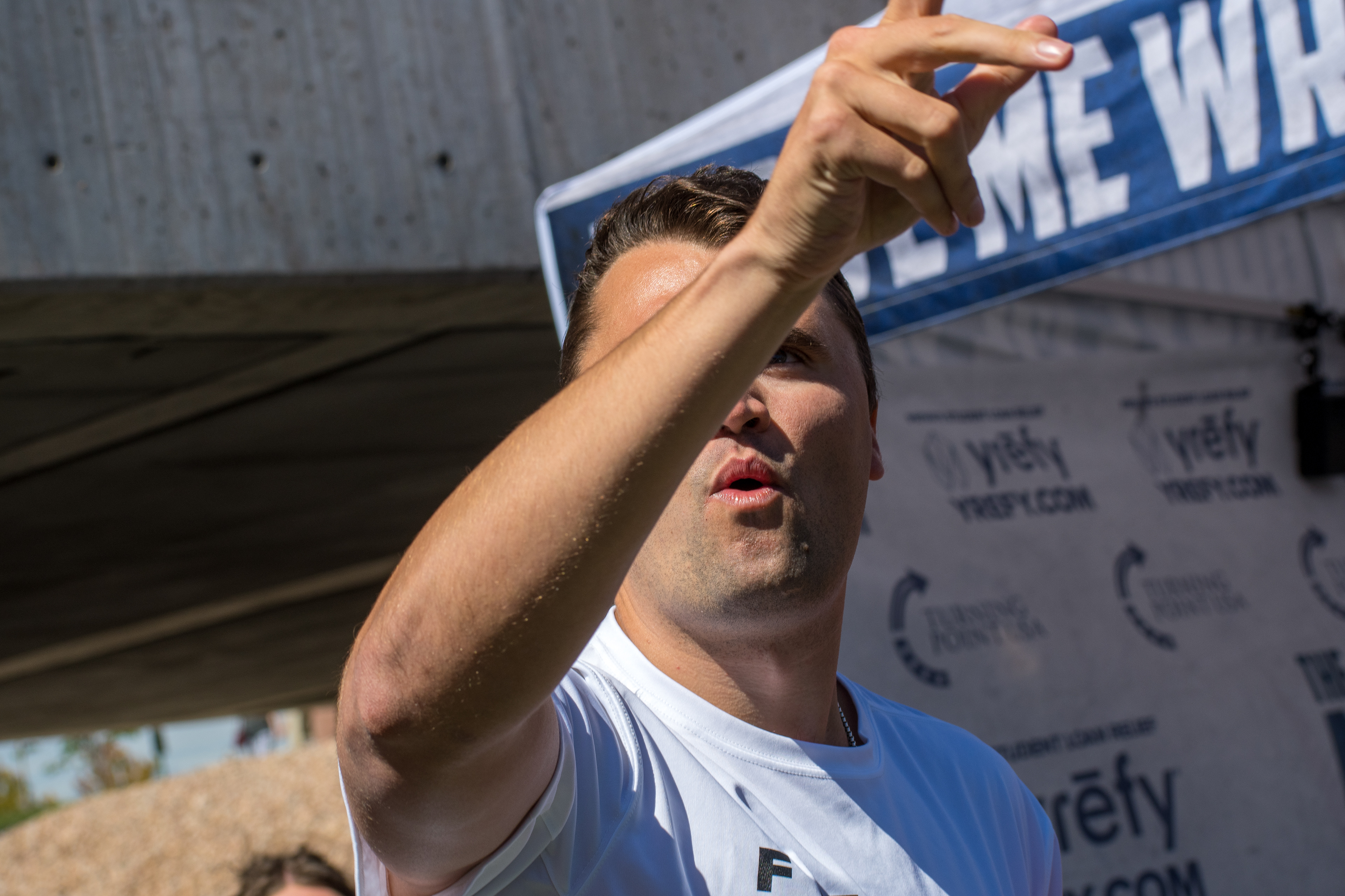 OREM, UTAH – SEPTEMBER 10, 2025: Charlie Kirk speaks with attendees during a public event at Utah Valley University. Positioned near a promotional booth and surrounded by supporters, Kirk appears engaged and expressive in one of his final public moments. The image reflects the atmosphere of direct outreach and energized dialogue that defined the gathering. © Charles-McClintock Wilson / ZUMA Press