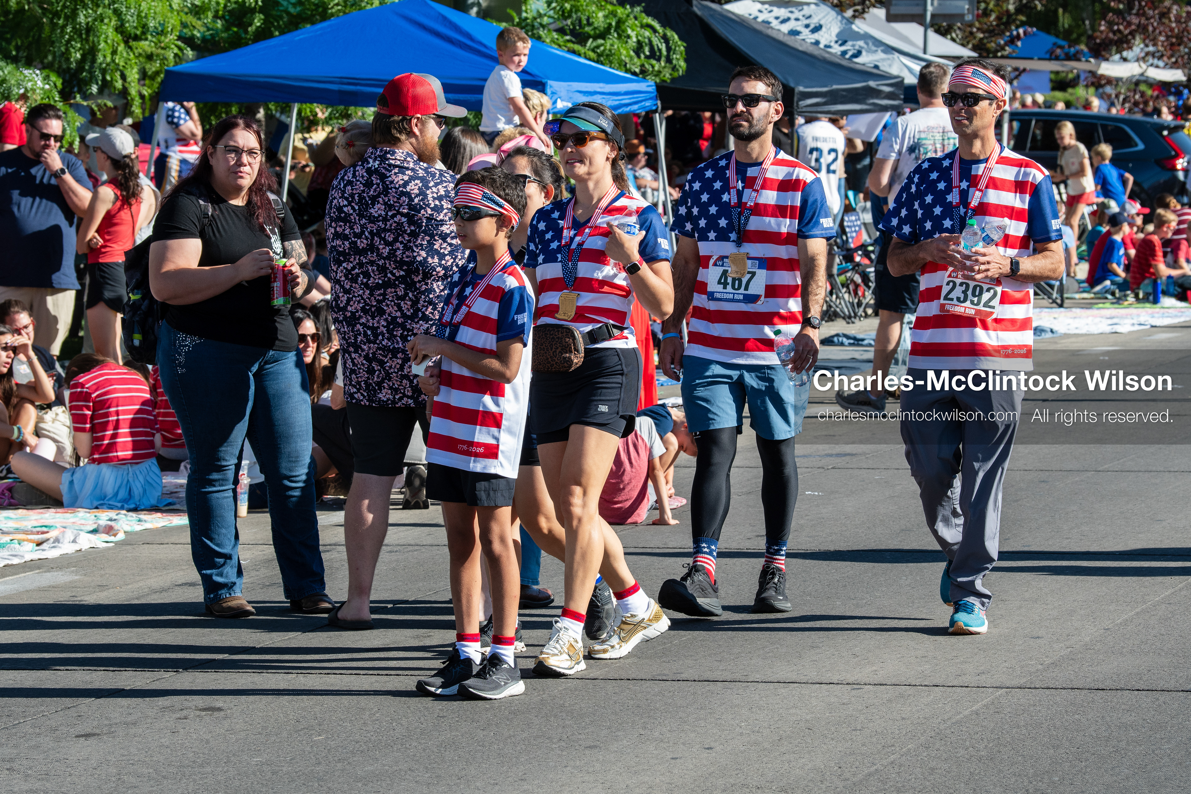 July 4, 2026, Provo, Utah, USA: Participants wearing matching patriotic stars and stripes shirts walk along the street before the start of America's Freedom Festival Grand Parade in Provo, Utah, Saturday, July 4, 2026. The annual Independence Day event features expanded programming to honor the 250th anniversary of United States independence. (Credit Image: © Charles-McClintock Wilson/ZUMA Press Wire)