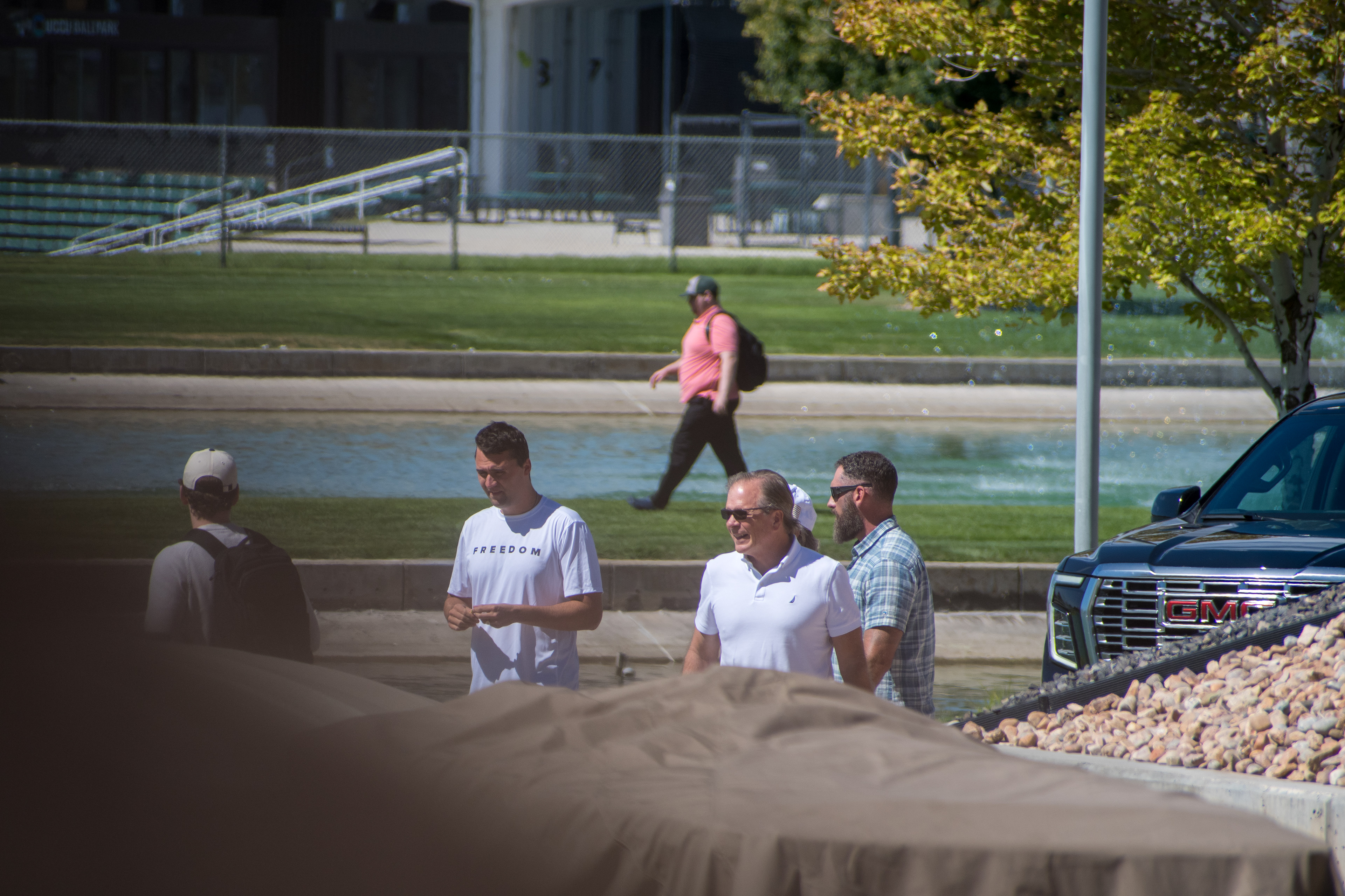 OREM, UTAH – SEPTEMBER 10, 2025: Charlie Kirk arrives at Utah Valley University for a scheduled public event. Walking near a water feature and surrounded by staff and supporters, Kirk enters the venue in a moment of calm anticipation. The image marks the beginning of his final public appearance, reflecting the quiet buildup before the crowd engagement that followed. © Charles-McClintock Wilson / ZUMA Press