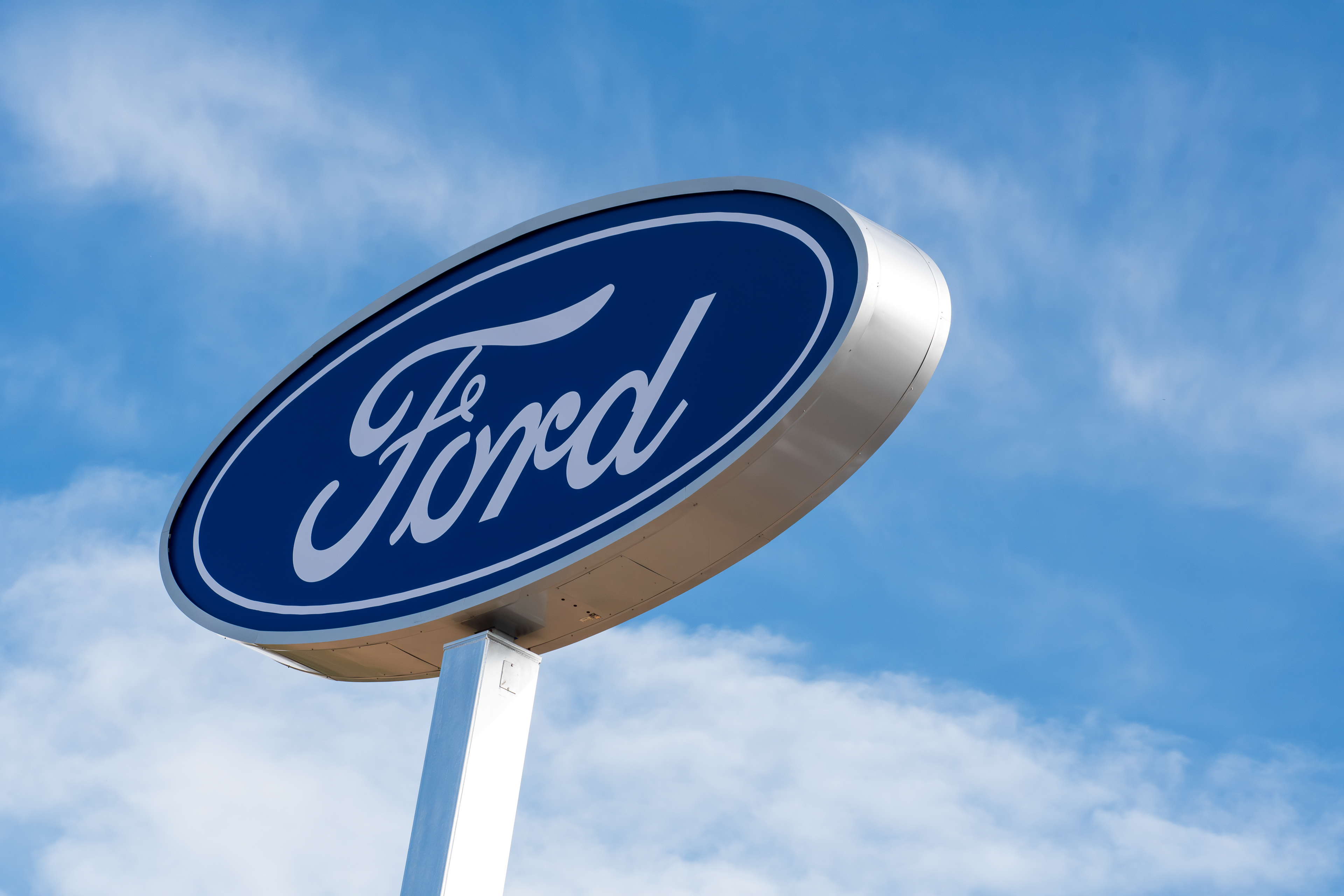 Spanish Fork, Utah, USA – May 28, 2025: A Ford dealership sign stands against a clear blue sky as the automaker recalls over 1 million U.S. vehicles due to faulty rearview camera software.