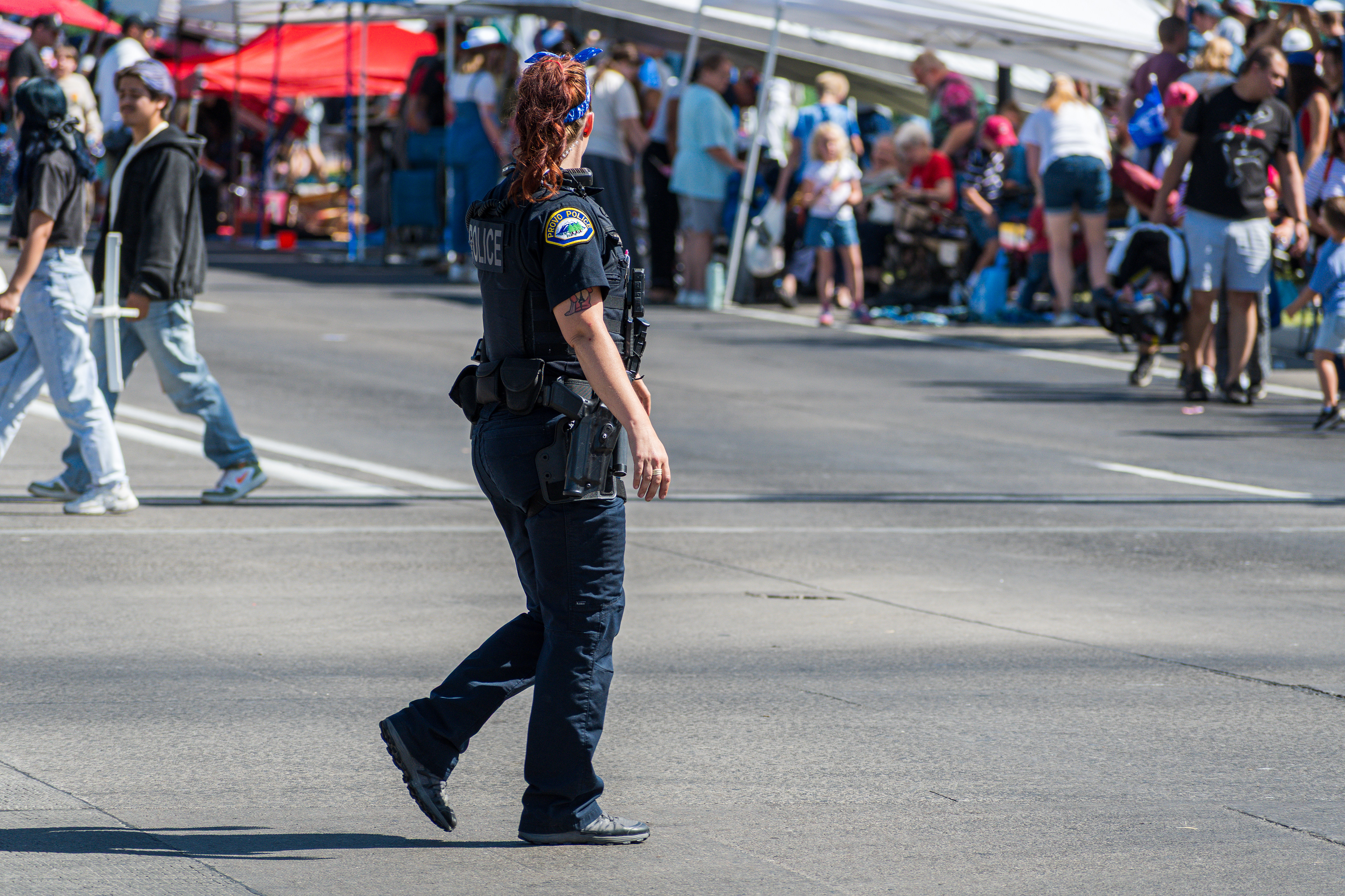 Provo, Utah – July 4, 2025: A female law enforcement officer walks along the parade route during the Freedom Festival Grand Parade in downtown Provo.