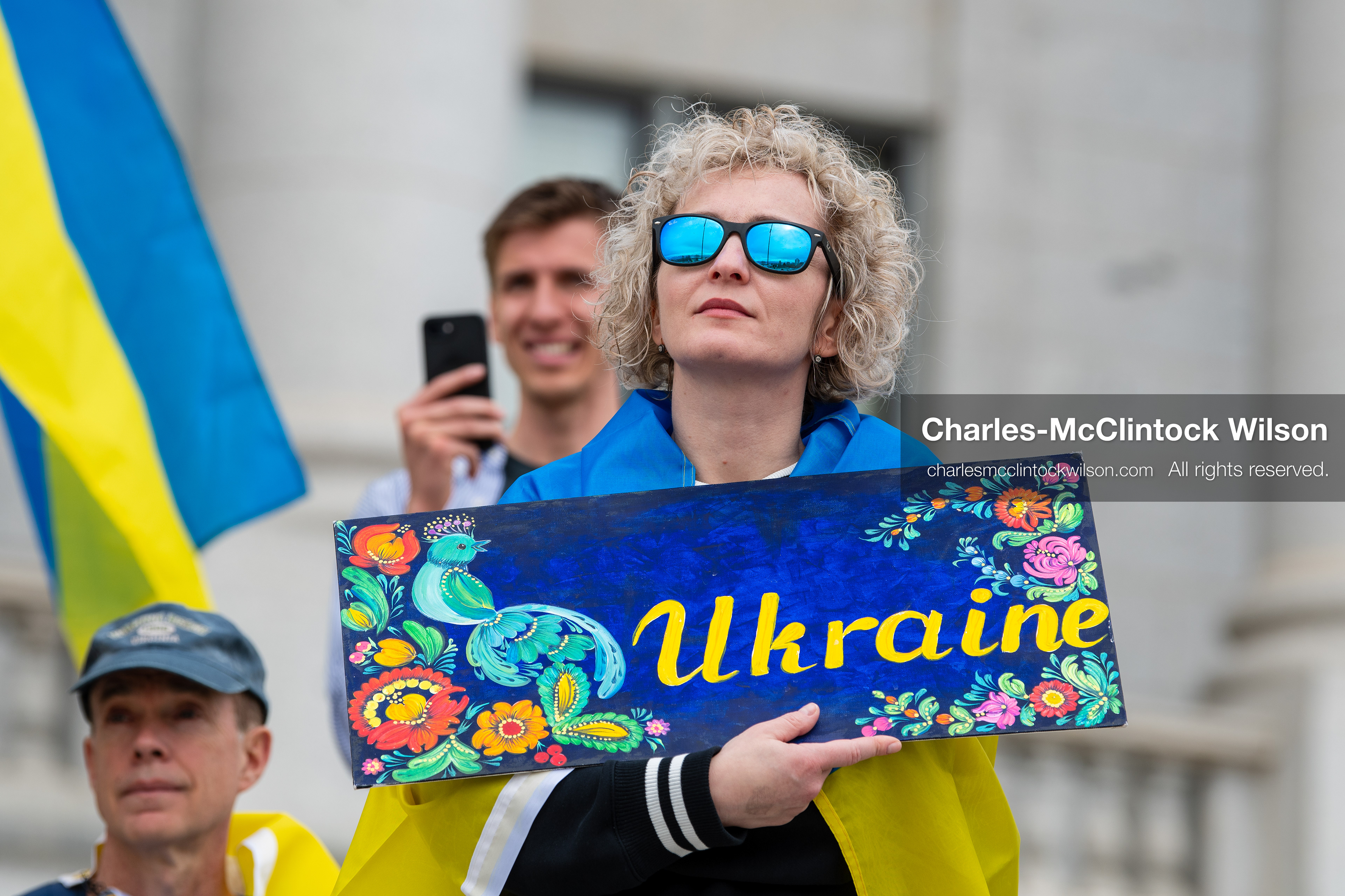 February 28, 2026, Salt Lake City, Utah, USA: A demonstrator draped in a Ukrainian flag holds a hand painted sign reading Ukraine during the Stand With Ukraine rally at the Utah State Capitol. The gathering marked the four year anniversary of the full scale Russian invasion of Ukraine and brought community members together in support of Ukrainians and local humanitarian efforts. (Credit Image: © Charles McClintock Wilson/ZUMA Press Wire)