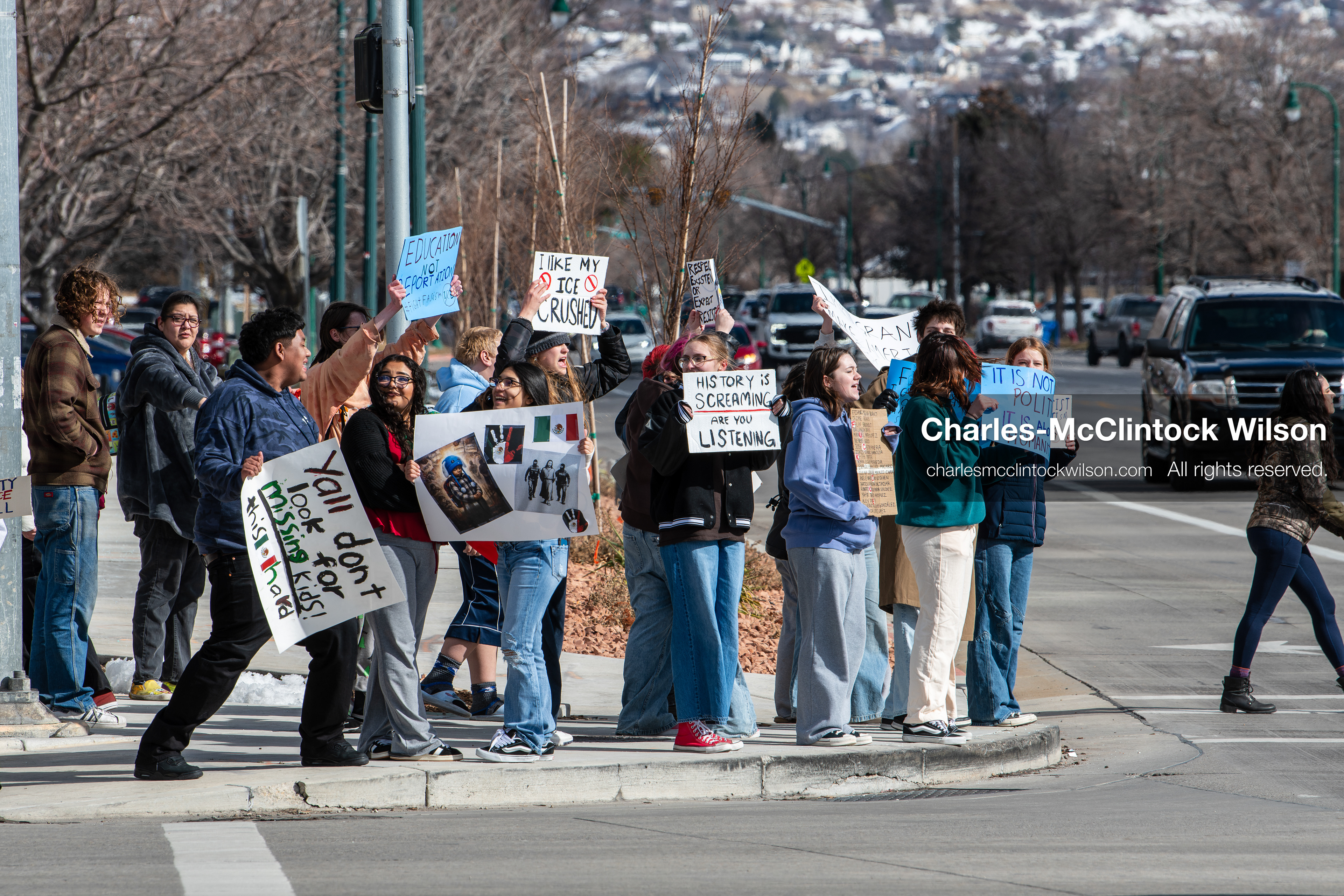 February 20, 2026, Orem, Utah, USA: High school students gather along State Street in front of Orem City Hall during a student led protest against ICE and federal immigration enforcement. Demonstrators hold signs as they stand near the roadway while traffic continues through the area. (Credit Image: © Charles McClintock Wilson/ZUMA Press Wire)