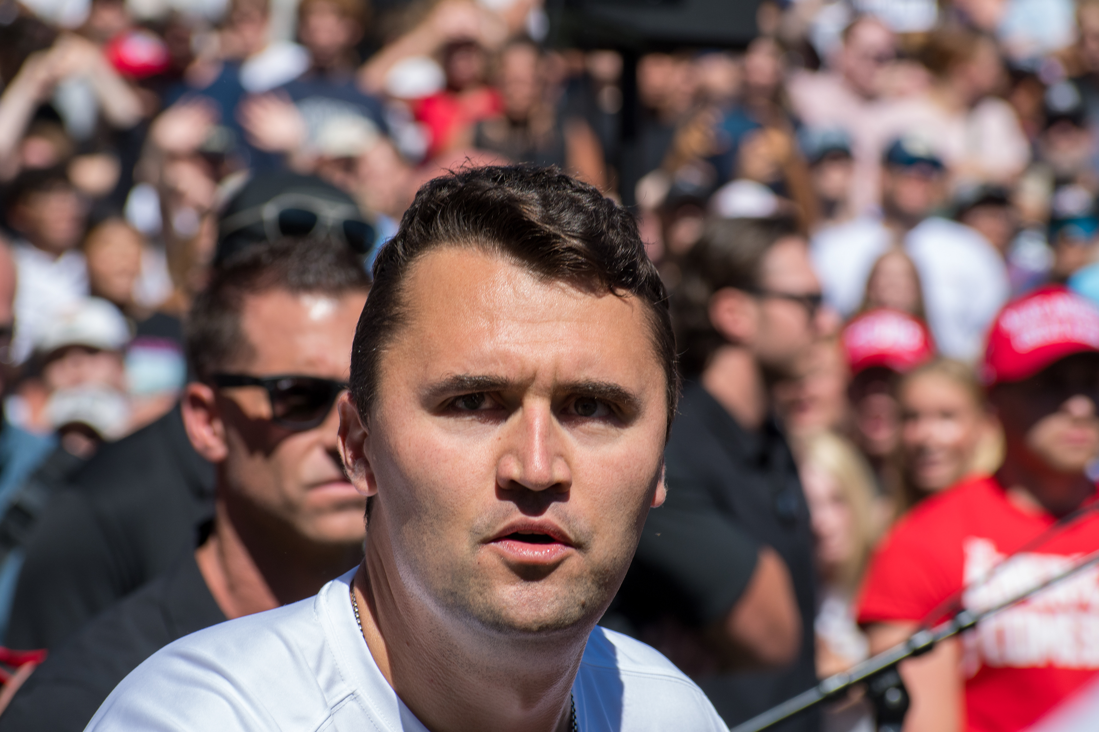 OREM, UTAH – SEPTEMBER 10, 2025: Charlie Kirk speaks with attendees during a public event at Utah Valley University. Positioned near a promotional booth and surrounded by supporters, Kirk appears engaged and expressive in one of his final public moments. The image reflects the atmosphere of direct outreach and energized dialogue that defined the gathering. © Charles-McClintock Wilson / ZUMA Press