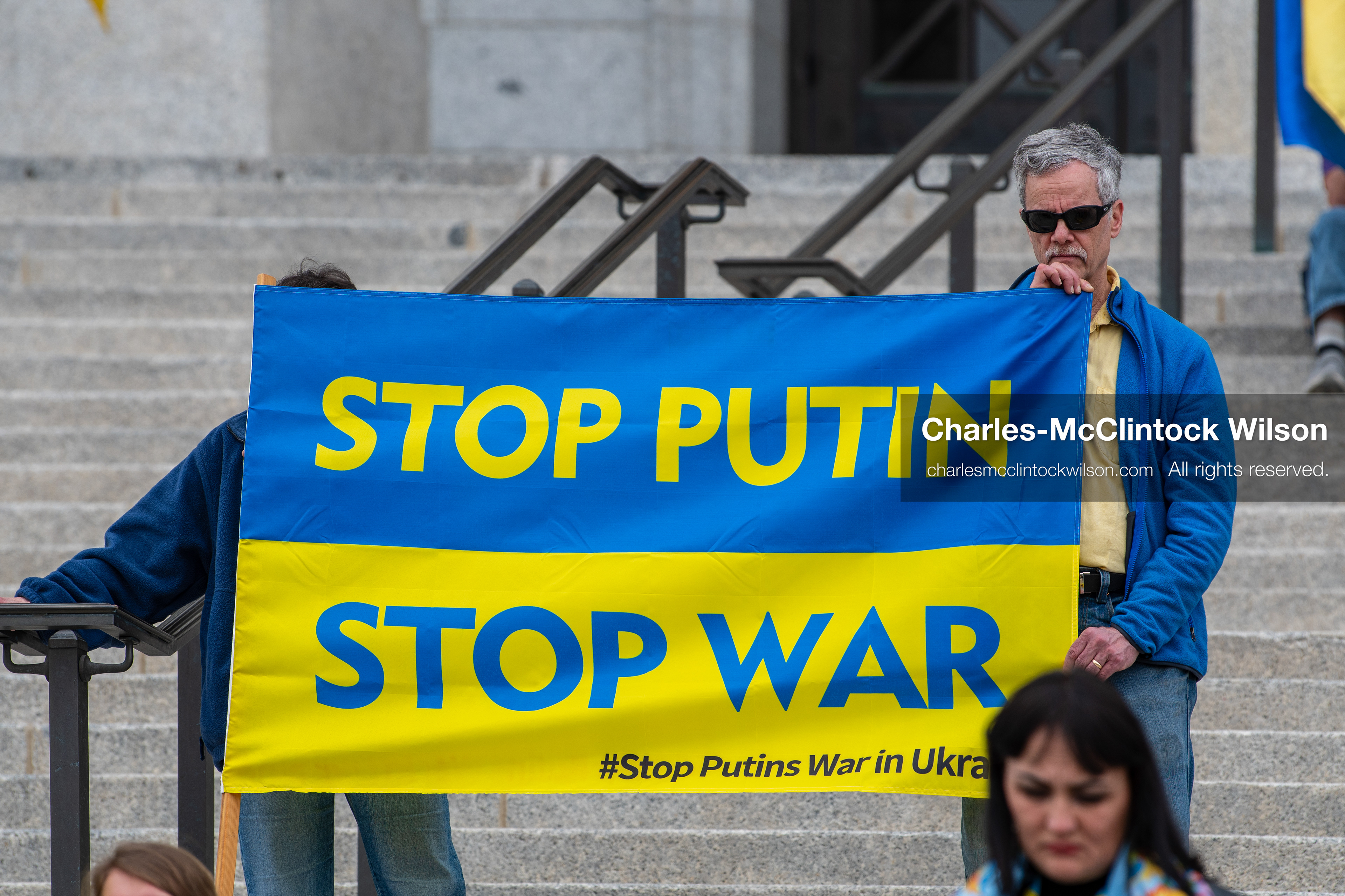  February 28, 2026, Salt Lake City, Utah, USA: Demonstrators hold a large blue and yellow banner resembling the Ukrainian flag with the words Stop Putin Stop War during the Stand With Ukraine rally at the Utah State Capitol. The gathering marked the four year anniversary of the full scale Russian invasion of Ukraine and brought community members together in support of Ukrainians and local humanitarian efforts. (Credit Image: © Charles McClintock Wilson/ZUMA Press Wire)