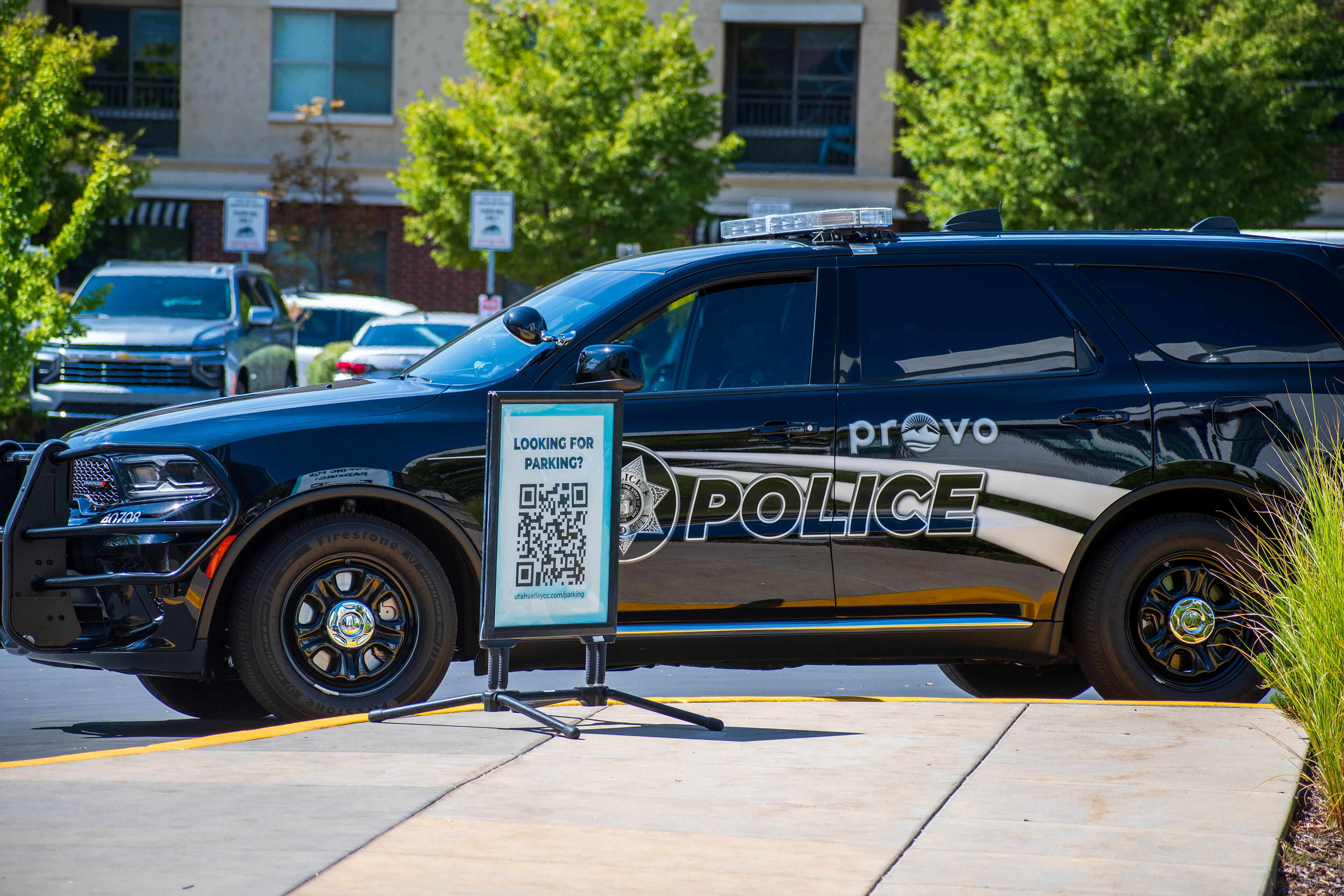 September 15, 2025 – Provo, Utah, United States: A Provo Police Department vehicle is parked near the Utah Valley Convention Center during a Department of Homeland Security career expo focused on recruiting law enforcement and security personnel. A nearby sign offers digital parking assistance via QR code. Photograph by Charles‑McClintock Wilson / ZUMA Press Wire