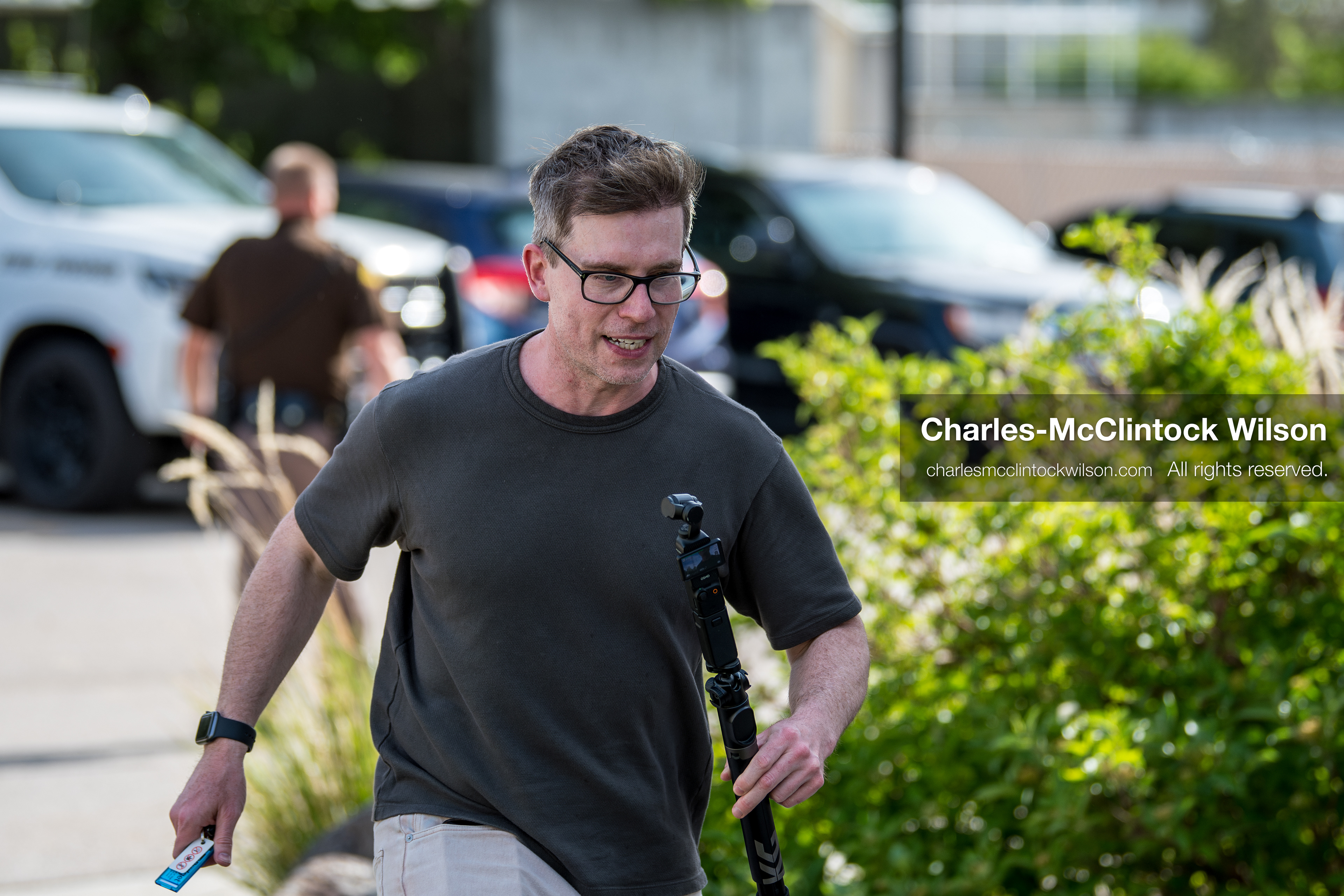 May 13, 2026, Brigham City, Utah, USA: US political satirist and digital creator WALTER MASTERSON walks outside the Box Elder County Justice Courthouse in Brigham City, Utah, carrying video equipment during a gathering over the proposed data‑center project backed by businessman Kevin O’Leary, which has drawn public concern over water use, power demand, and transparency. (Credit Image: © Charles‑McClintock Wilson/ZUMA Press Wire)
