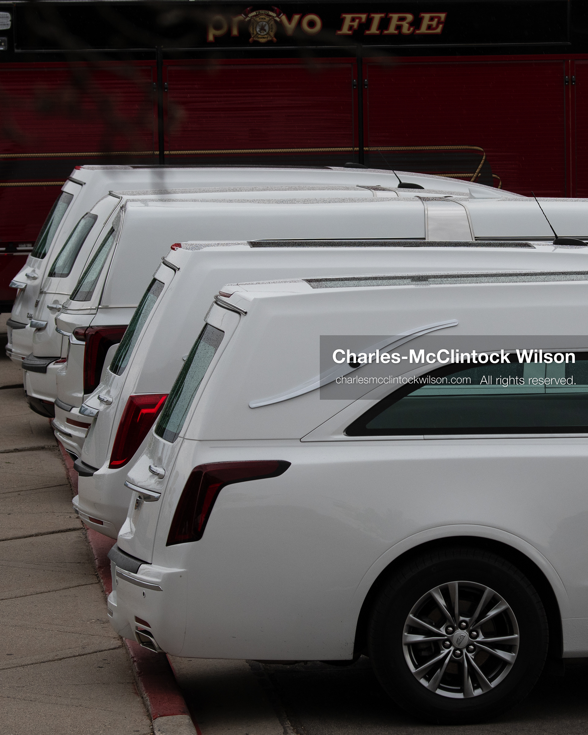 A close-up shot shows a line of white Cadillac hearses parked outside the UCCU Center at Utah Valley University in Orem, Utah, on Wednesday, July 29, 2026. More than 300 people came to the public memorial ceremony to honor Provo Fire Captain Spencer Long, his wife Katrina, and three of their sons, who died after a flash flood hit their campsite near the Sunglow Campground in Wayne County. (Photo by Charles-McClintock Wilson/Sipa USA)