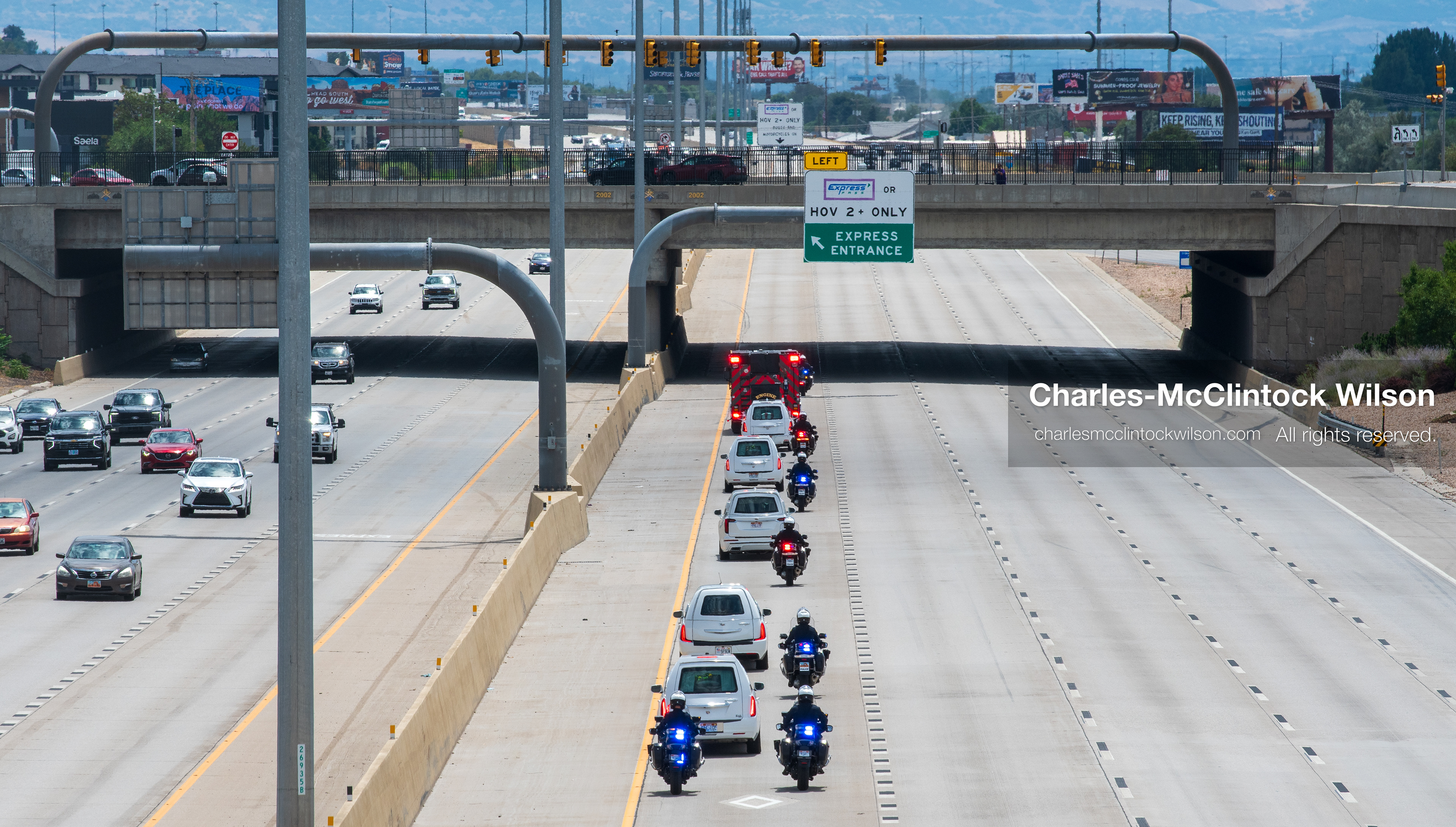 A motorcade of white hearses travels down Interstate 15 during a funeral procession for Provo Fire Captain Spencer Long and his family in Orem, Utah, on Wednesday, July 29, 2026. More than 300 people came to the public memorial ceremony to honor the five family members who died after a flash flood hit their campsite near the Sunglow Campground in Wayne County. (Photo by Charles-McClintock Wilson/Sipa USA)