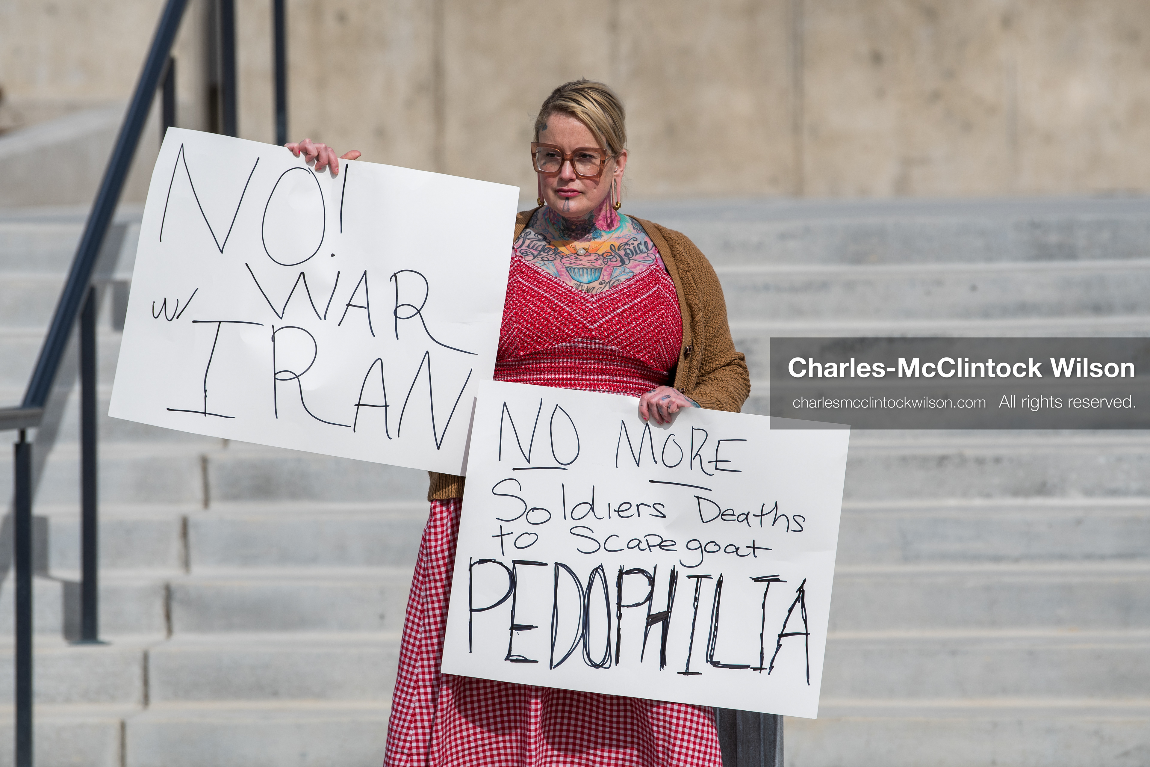 February 28, 2026, Salt Lake City, Utah, USA: A demonstrator stands on the steps of the Utah State Capitol holding two handwritten protest signs during the Stand With Ukraine rally. The gathering marked the four year anniversary of the full scale Russian invasion of Ukraine and brought community members together in support of Ukrainians and local humanitarian efforts. (Credit Image: © Charles McClintock Wilson/ZUMA Press Wire)