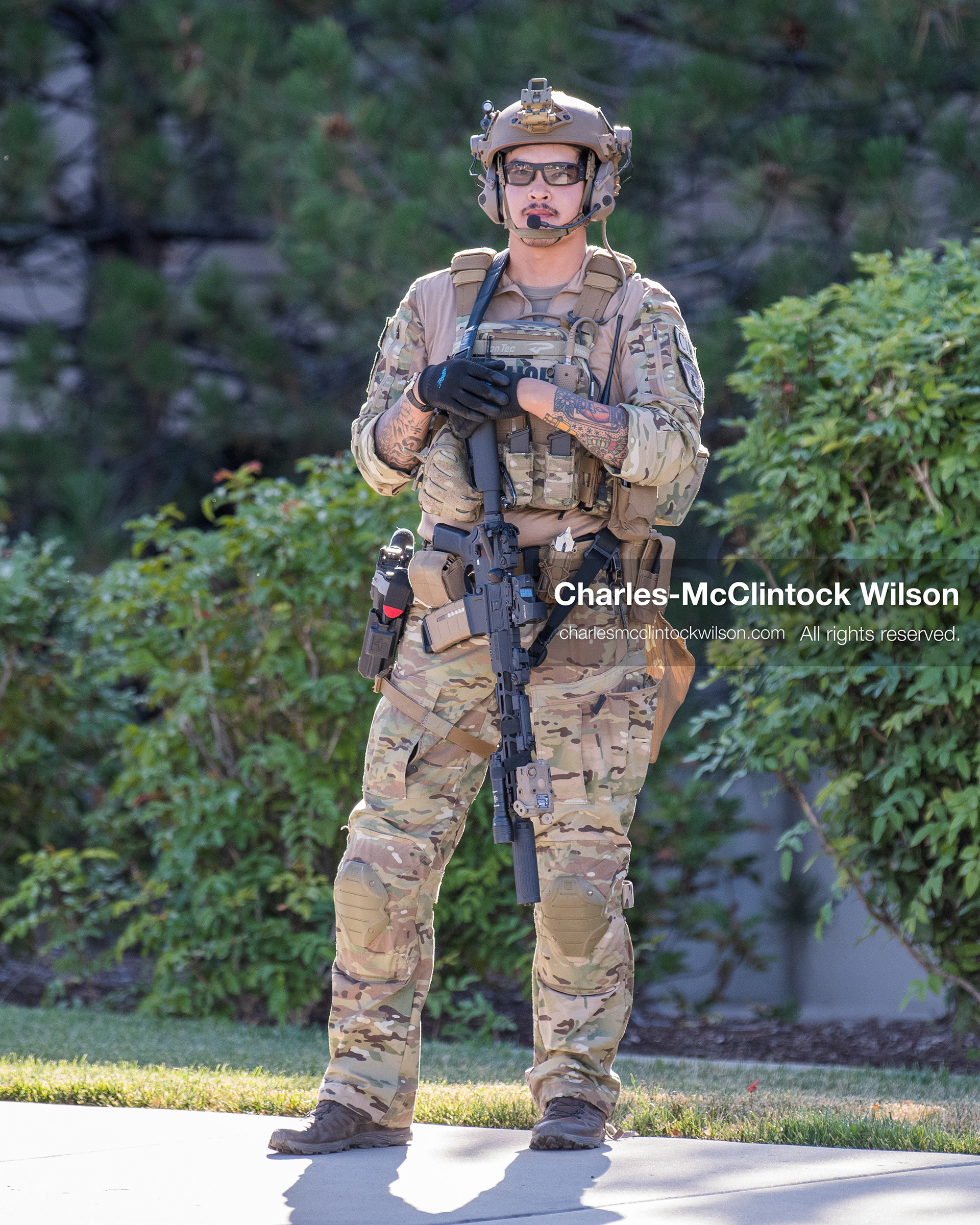 An armed law enforcement officer wearing a helmet and tactical gear stands guard outside Intermountain Medical Center in Murray, Utah, United States, on August 17, 2026. Multiple regional police agencies secured the hospital perimeter as a safety precaution after shooting victims were admitted following a fatal shootout outside a funeral service in nearby Kearns. (Photo by Charles-McClintock Wilson/NurPhoto)