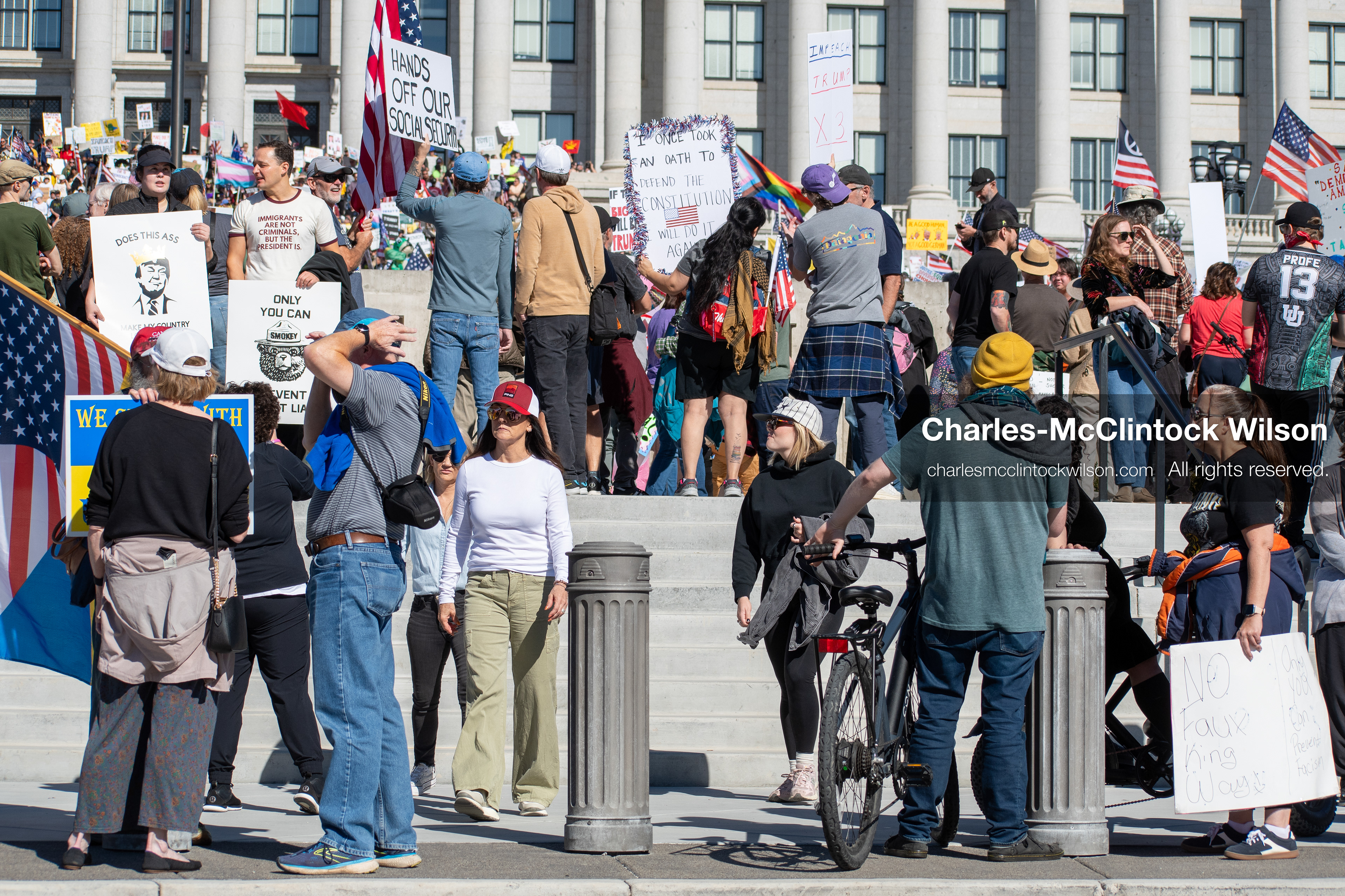 October 18, 2025, Salt Lake City, Utah, USA: Demonstrators participate in a "No Kings" protest held at the Utah State Capitol. Participants hold signs and flags during the public gathering.