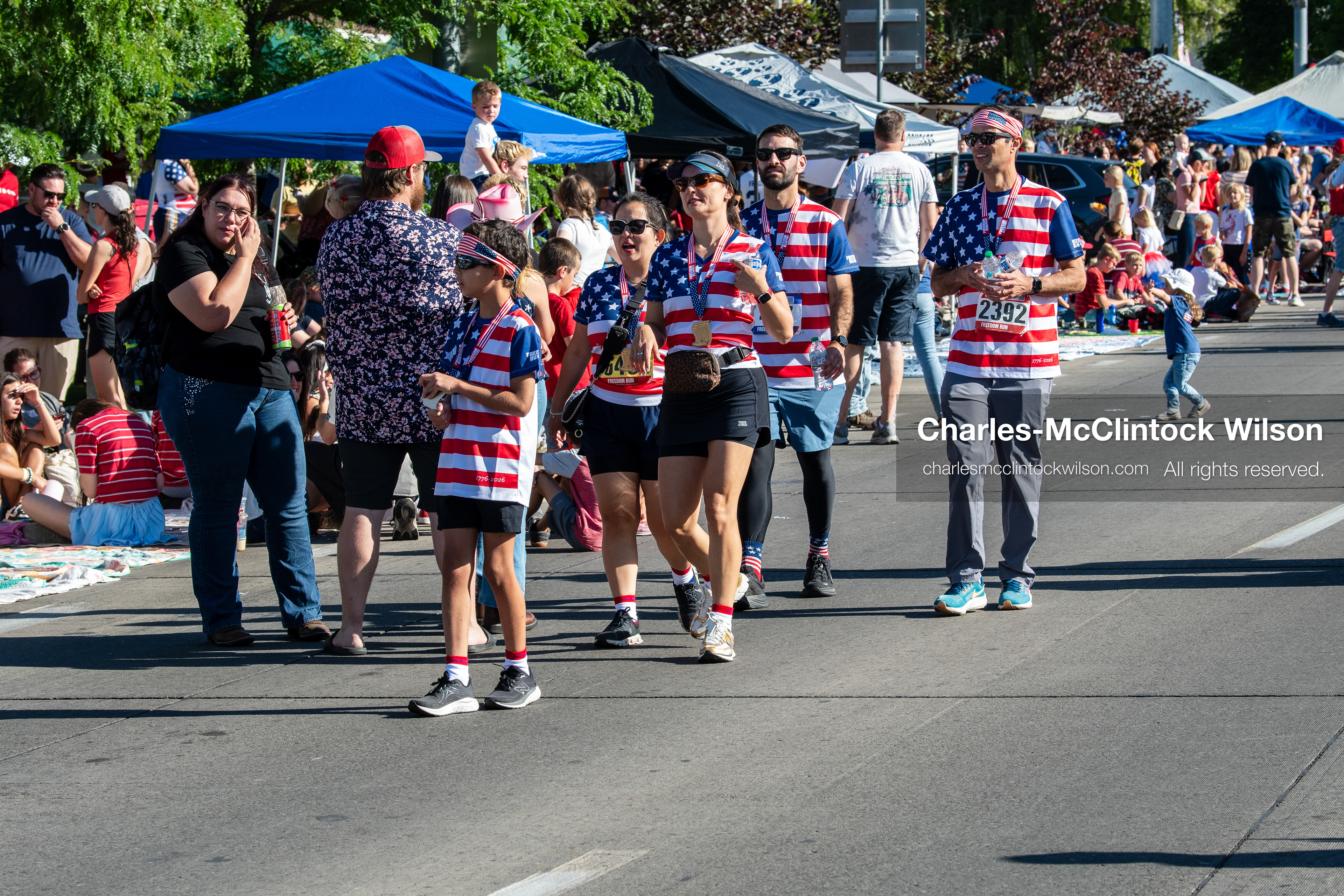 July 4, 2026, Provo, Utah, USA: Participants wearing matching patriotic stars and stripes shirts walk along the street before the start of America's Freedom Festival Grand Parade in Provo, Utah, Saturday, July 4, 2026. The annual Independence Day event features expanded programming to honor the 250th anniversary of United States independence. (Credit Image: © Charles-McClintock Wilson/ZUMA Press Wire)