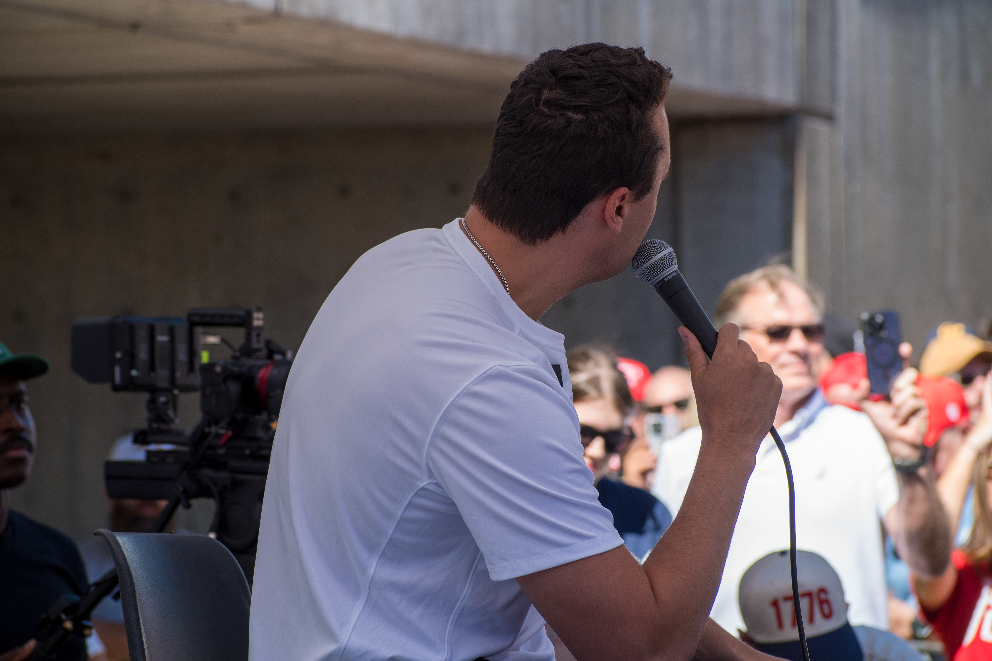 OREM, UTAH – SEPTEMBER 10, 2025: Charlie Kirk addresses supporters during a public event at Utah Valley University. Speaking into a handheld microphone, Kirk stands before a crowd of attendees—some recording the moment, others cheering in red hats—as media crews document the scene. The image reflects Kirk’s direct engagement and the energized atmosphere that defined his final public appearance. © Charles-McClintock Wilson / ZUMA Press