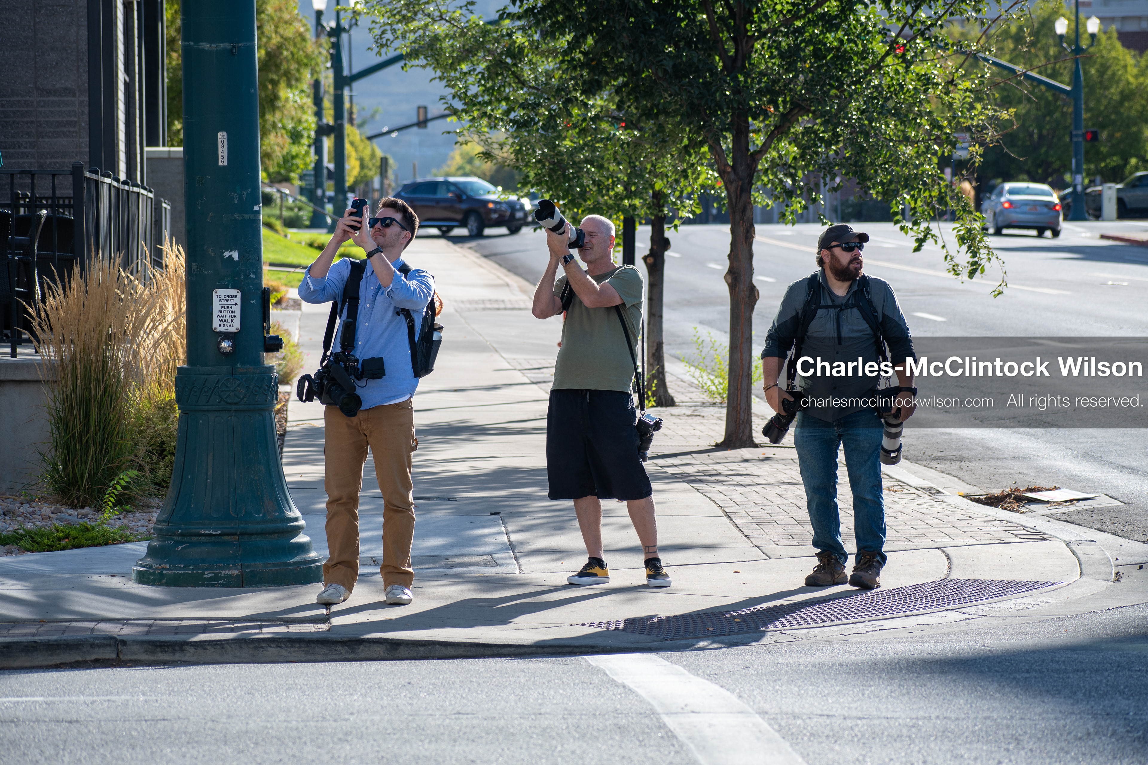 SEPTEMBER 29, 2025 — PROVO, UTAH, USA: Three photographers stand near a street intersection outside the Utah County Court during a waiver hearing for Tyler Robinson. Robinson, charged with aggravated murder in the September 10 shooting death of conservative activist Charlie Kirk at Utah Valley University, appeared virtually for the proceedings. Members of the press documented the hearing from multiple vantage points as law enforcement maintained a visible perimeter. (Credit Image: © Charles‑McClintock Wilson / ZUMA Press Wire)