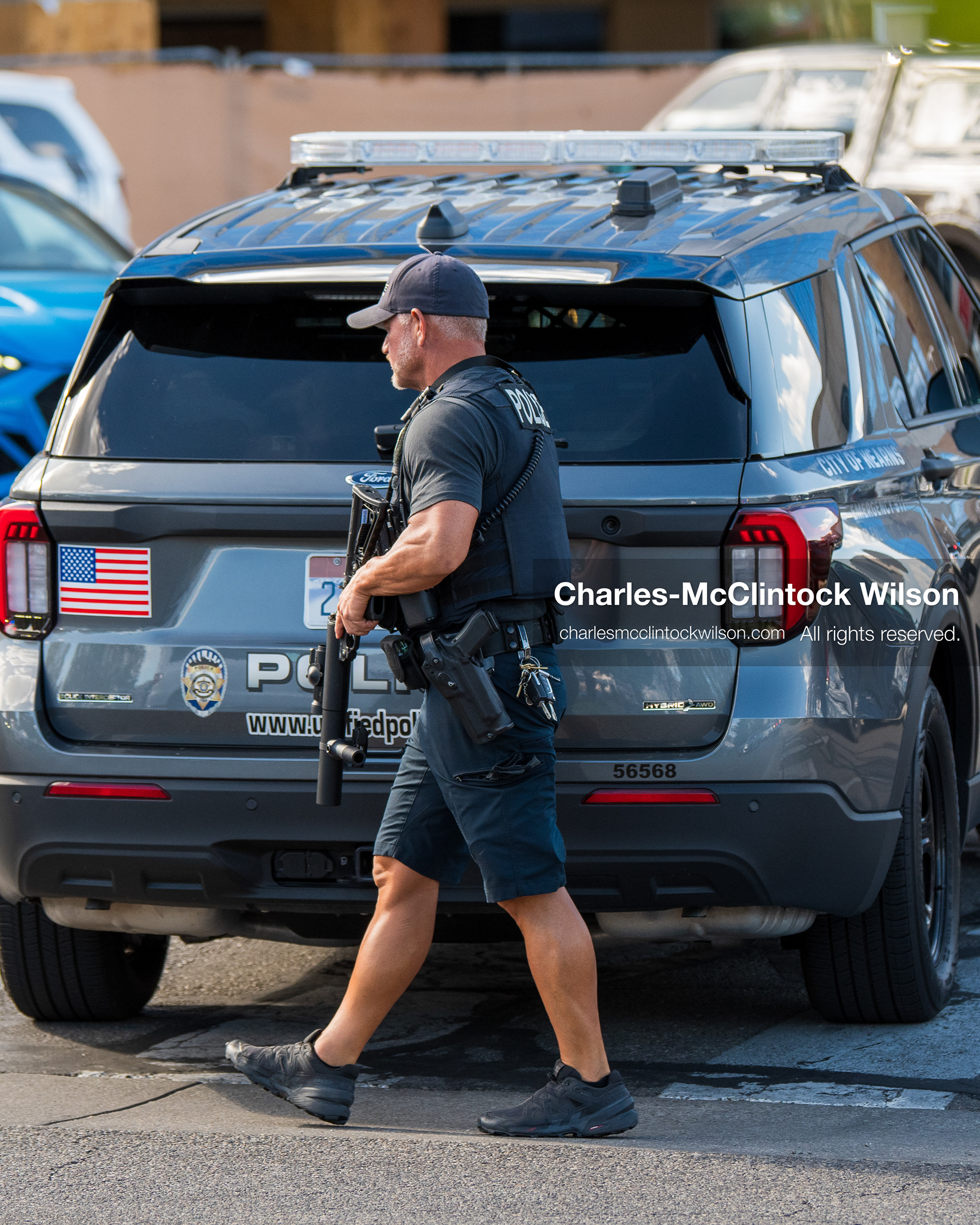 August 17, 2026, Murray, Utah, USA: A local police officer walks along the sidewalk perimeter monitoring traffic outside Intermountain Medical Center on Monday. Multiple police agencies secured the hospital perimeter as a safety precaution after shooting victims were brought in from a fatal shootout outside a funeral in nearby Kearns. (Credit Image: © Charles McClintock Wilson/ZUMA Press Wire)
