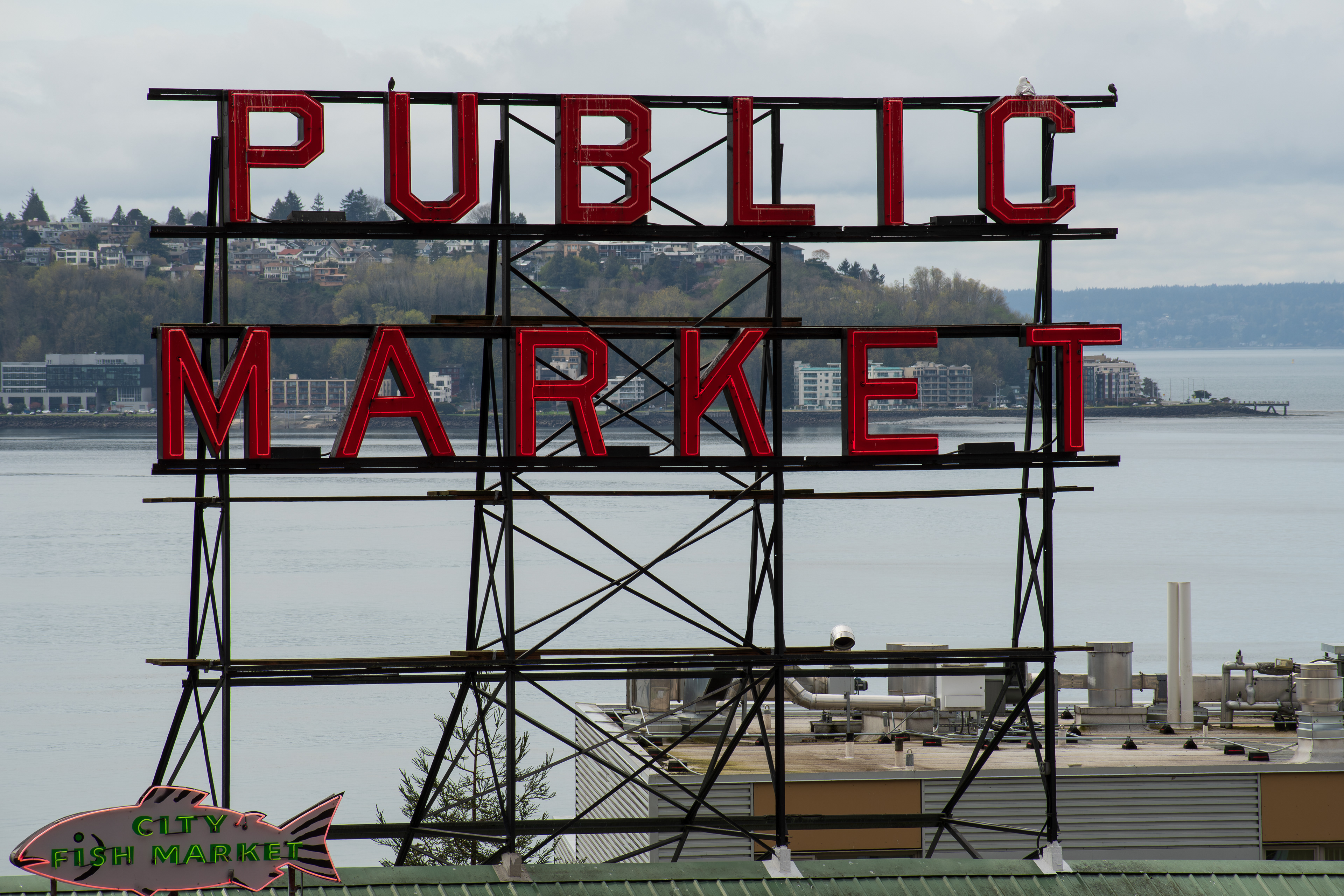 SEATTLE, WA, USA - APR 7, 2025: Public Market Sign at the landmark Pike Place Market in downtown Seattle, Washington, United States on a cloudy day. The market opened on August 17, 1907. 