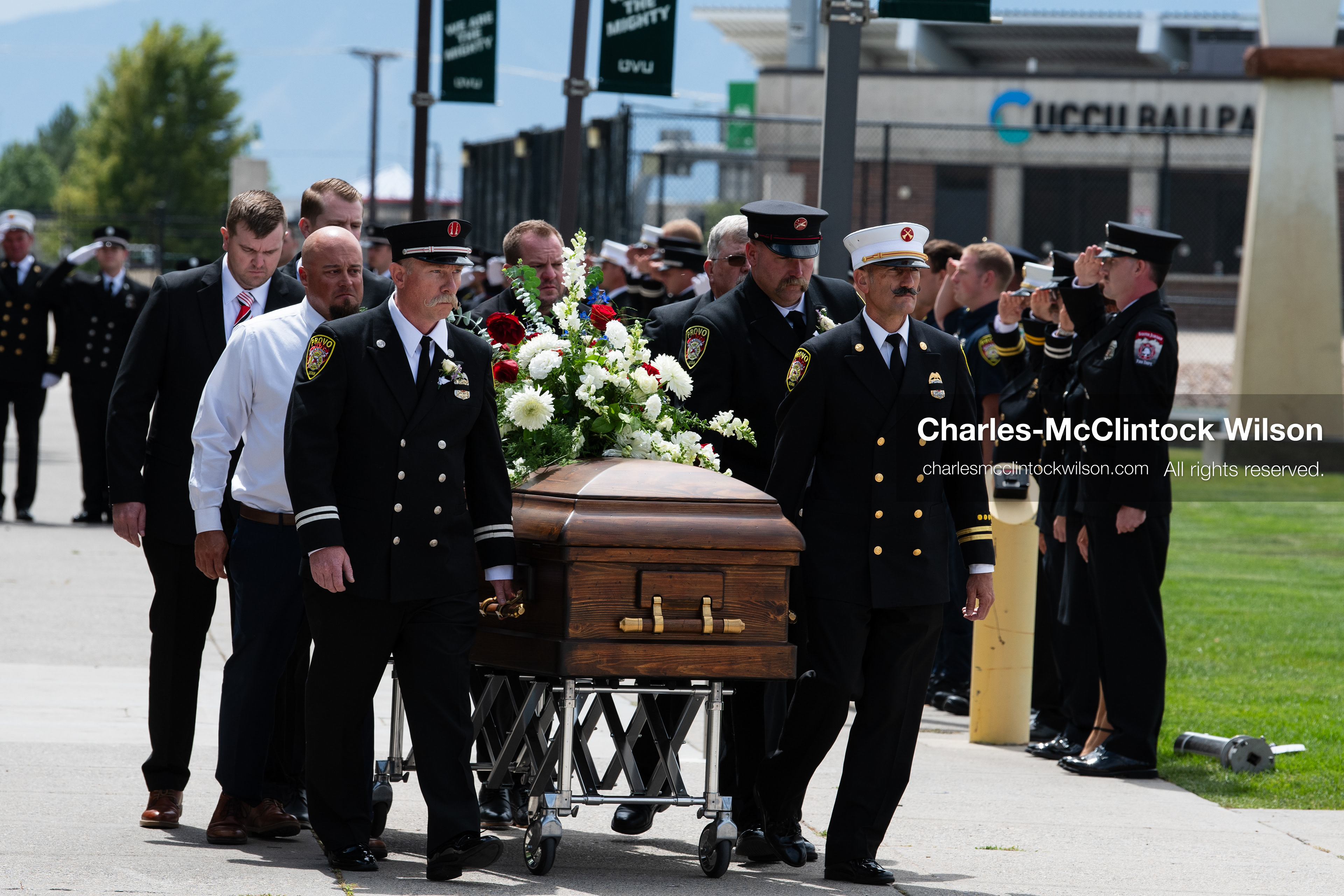 Firefighters and pallbearers escort the casket of Provo Fire Captain Spencer Long outside the UCCU Center on the campus of Utah Valley University in Orem, Utah, on Wednesday, July 29, 2026. More than 300 people came to the public memorial ceremony to honor Captain Long, his wife Katrina, and three of their sons, who died after a flash flood hit their campsite near the Sunglow Campground in Wayne County. (Photo by Charles-McClintock Wilson/Sipa USA)