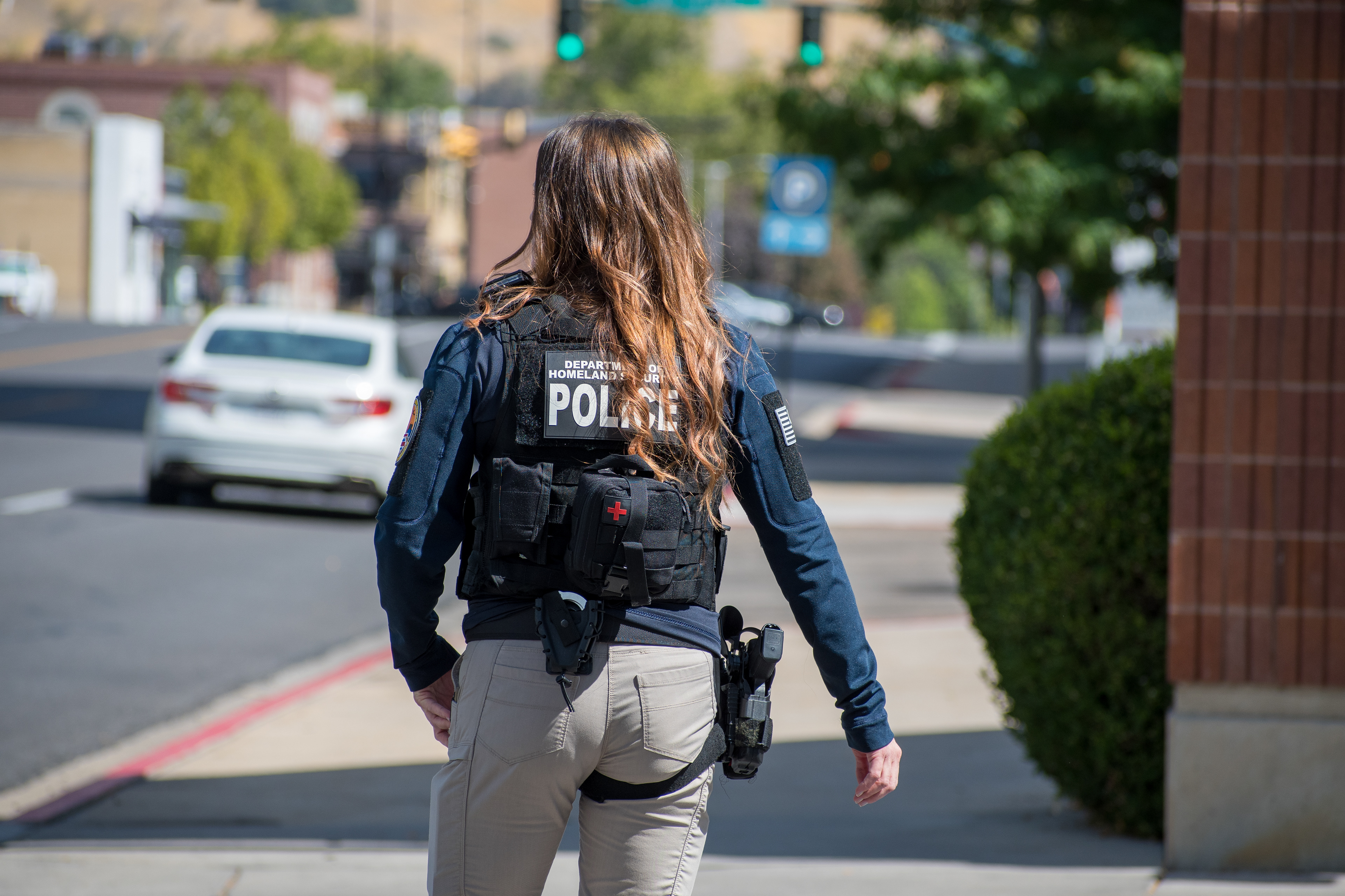 A Homeland Security police officer walks near the Utah Valley Convention Center during a Department of Homeland Security career expo focused on recruiting law enforcement and security personnel. Photograph by Charles‑McClintock Wilson / ZUMA Press Wire