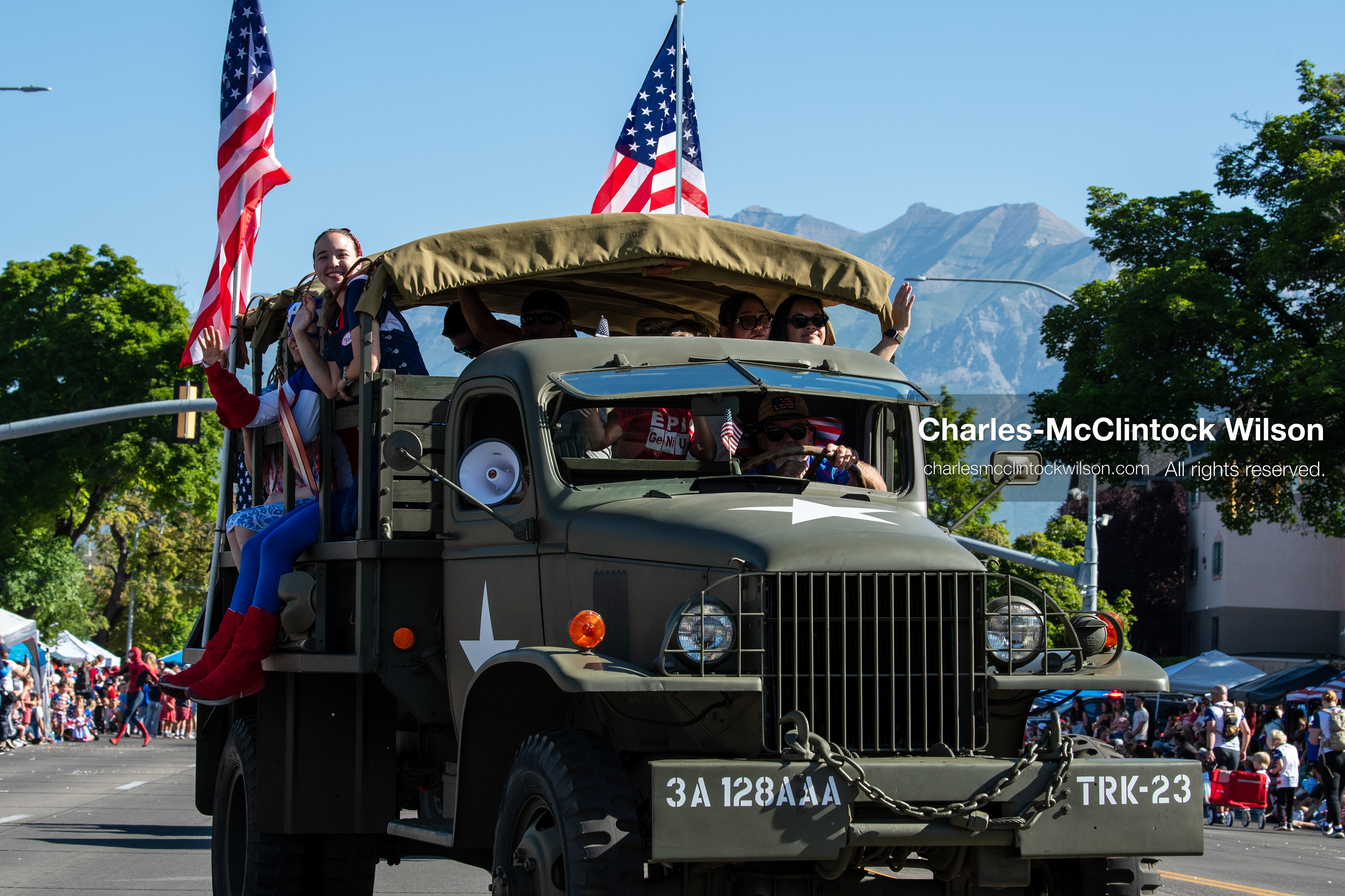 July 4, 2026, Provo, Utah, USA: A vintage military truck carrying passengers and flying American flags drives down the route during America's Freedom Festival Grand Parade in Provo, Utah, Saturday, July 4, 2026. The annual event drew thousands of spectators to the downtown corridor. (Credit Image: © Charles-McClintock Wilson/ZUMA Press Wire)