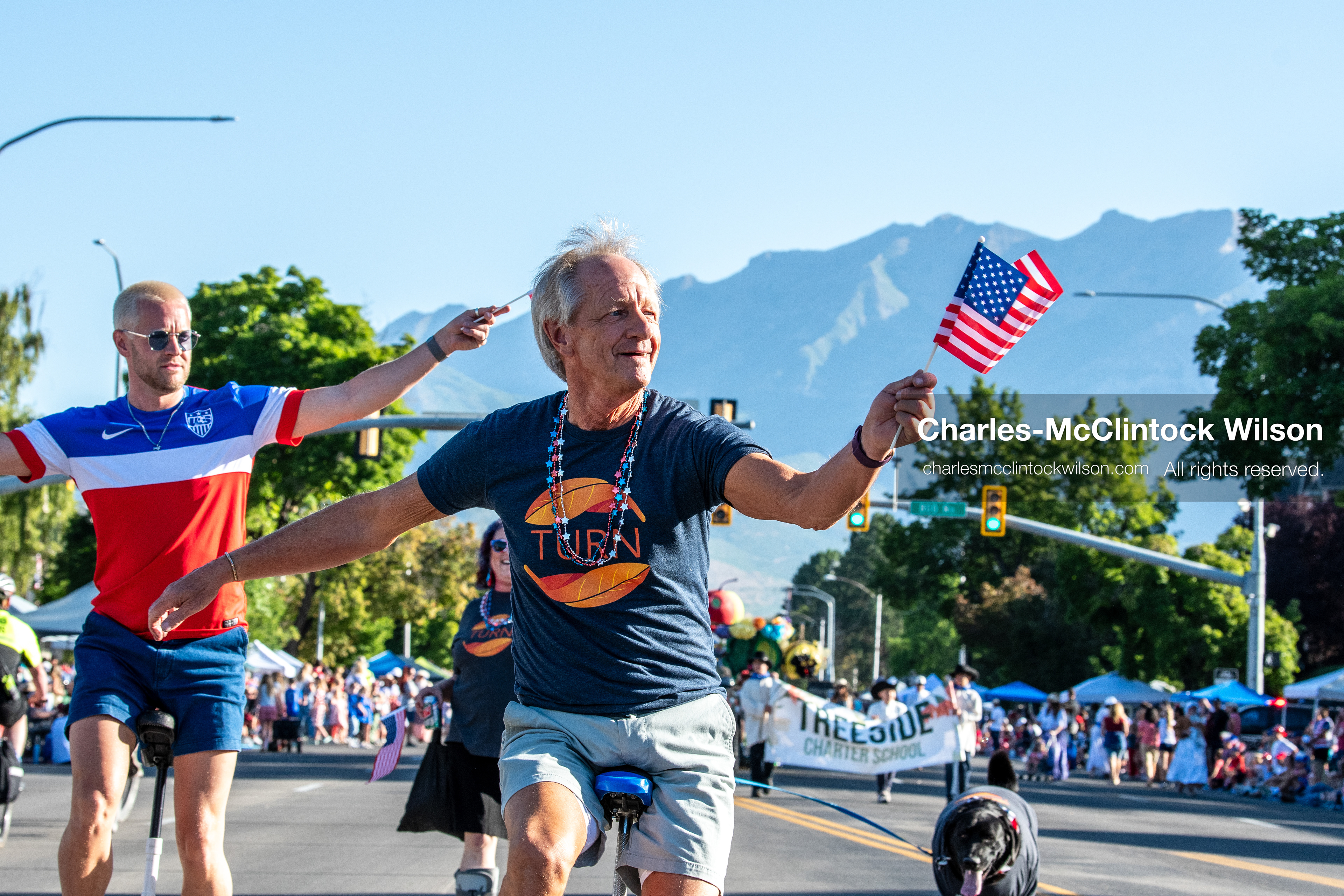 July 4, 2026, Provo, Utah, USA: A man waves a small American flag while riding a unicycle down the street alongside another unicyclist during America's Freedom Festival Grand Parade in Provo, Utah, Saturday, July 4, 2026. The annual Independence Day event features expanded programming to honor the 250th anniversary of United States independence. (Credit Image: © Charles-McClintock Wilson/ZUMA Press Wire)