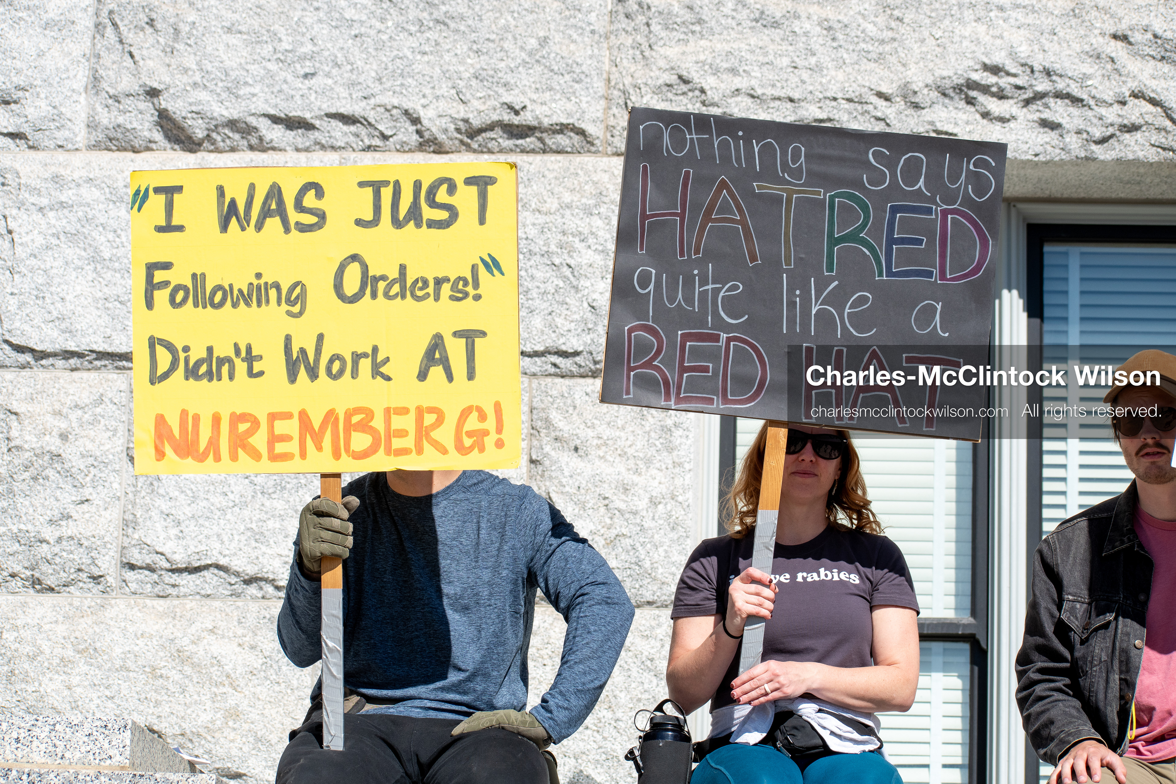 October 18, 2025, Salt Lake City, Utah, USA: Demonstrators sit on a stone ledge during a "No Kings" protest at the Utah State Capitol. The protest was part of a nationwide mobilization.