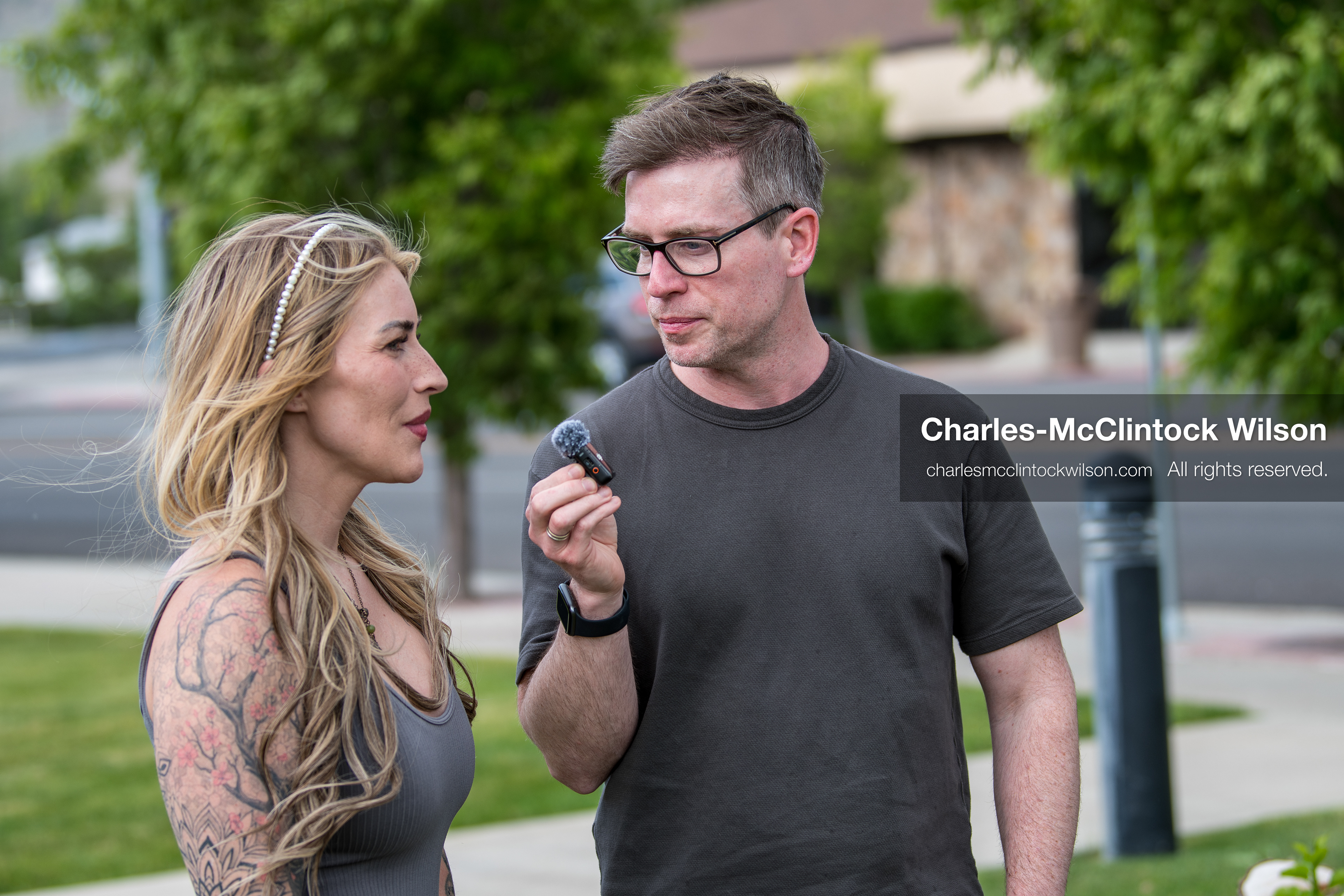 May 13, 2026, Brigham City, Utah, USA: US political satirist and digital creator WALTER MASTERSON interviews a woman outside the Box Elder County Justice Courthouse in Brigham City, Utah, during a gathering over the proposed data‑center project backed by businessman Kevin O’Leary, which has drawn public concern over water use, power demand, and transparency. (Credit Image: © Charles‑McClintock Wilson/ZUMA Press Wire)
