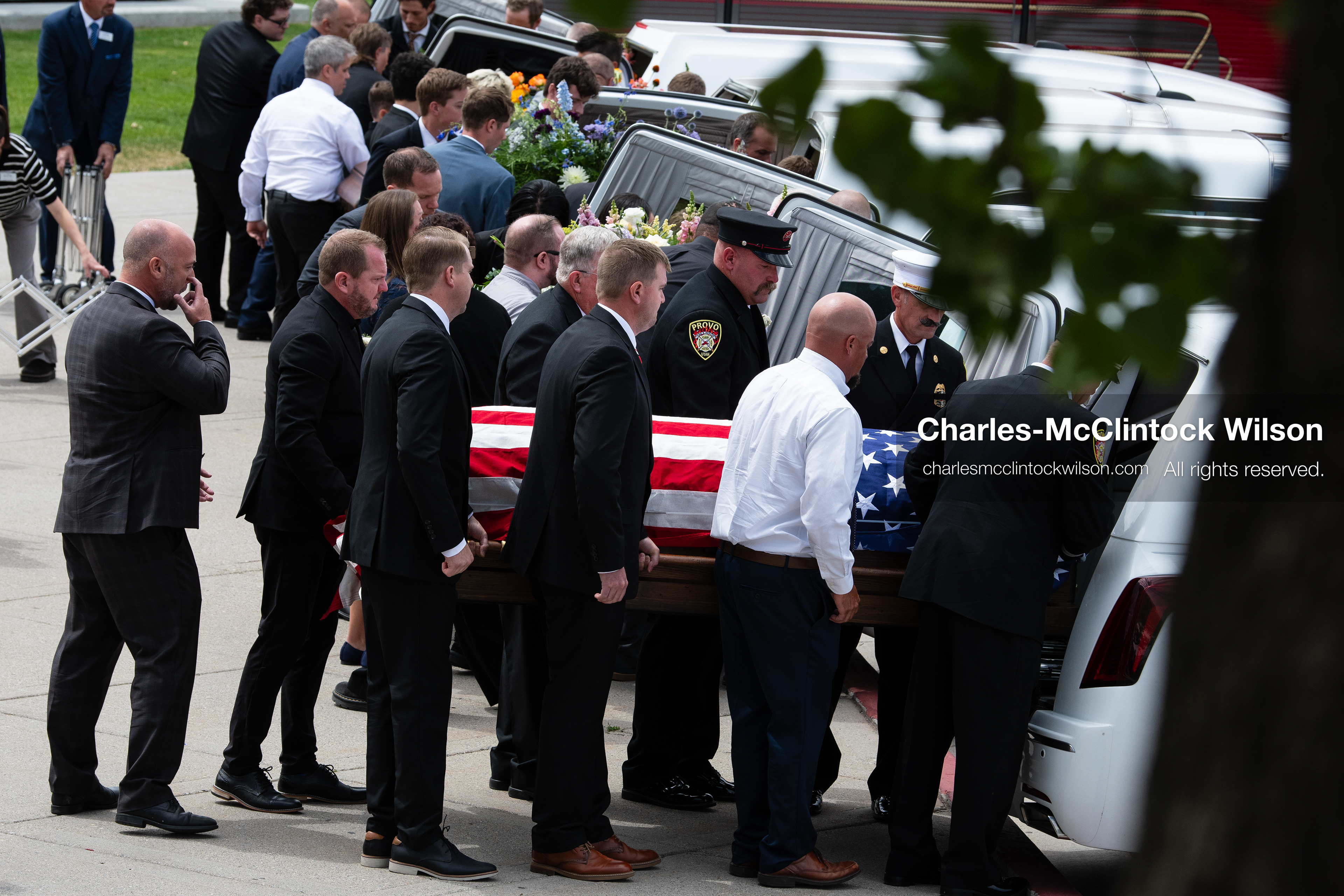 Firefighters and pallbearers load the flag-draped casket of Provo Fire Captain Spencer Long into a white hearse outside the UCCU Center at Utah Valley University in Orem, Utah, on Wednesday, July 29, 2026. More than 300 people came to the public memorial ceremony to honor Captain Long, his wife Katrina, and three of their sons, who died after a flash flood hit their campsite near the Sunglow Campground in Wayne County. (Photo by Charles-McClintock Wilson/Sipa USA)