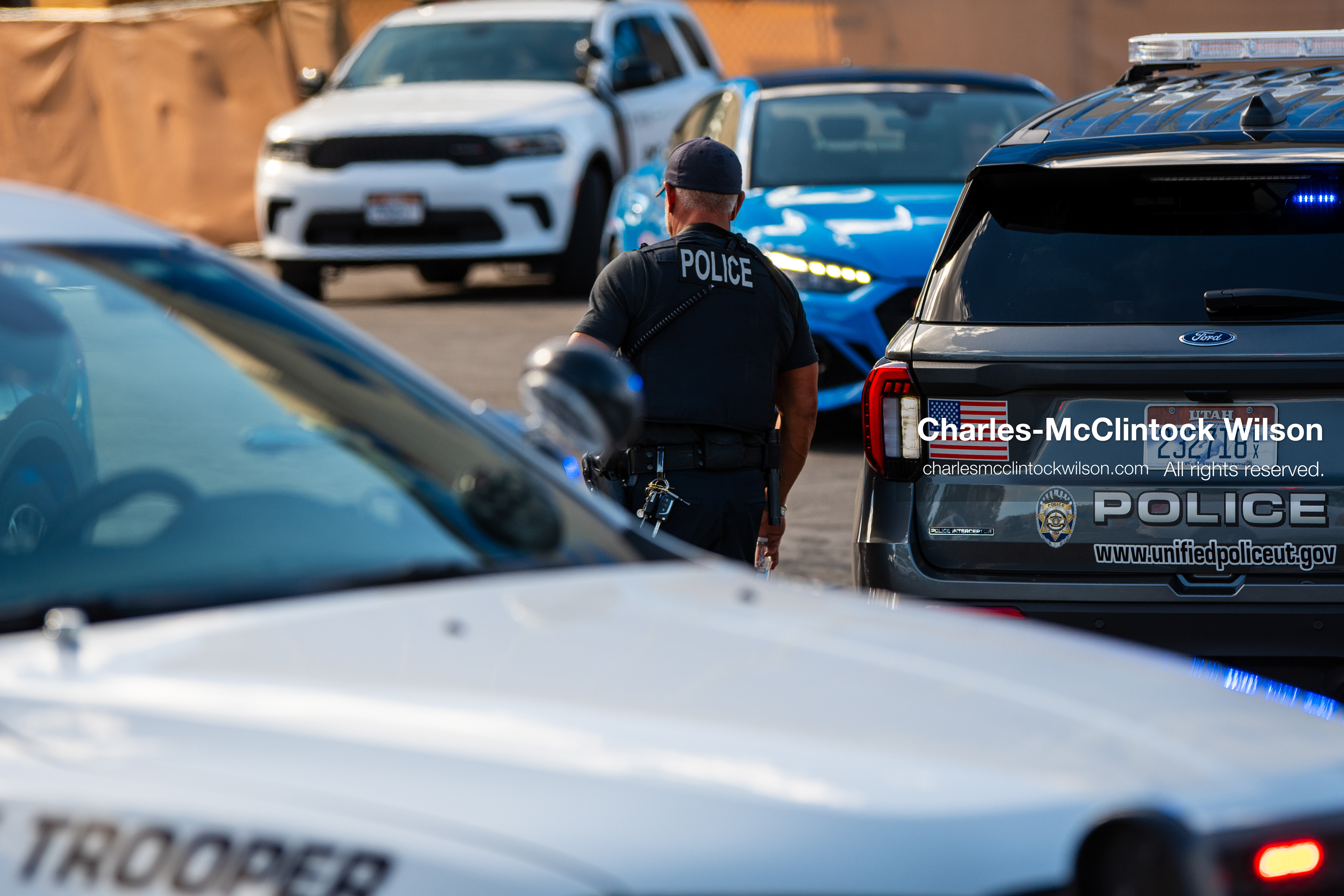 August 17, 2026, Murray, Utah, USA: A law enforcement officer walks among parked police cruisers and state trooper vehicles blocking a roadway outside Intermountain Medical Center on Monday. Multiple police agencies secured the hospital perimeter as a safety precaution after shooting victims were brought in from a fatal shootout outside a funeral in nearby Kearns. (Credit Image: © Charles McClintock Wilson/ZUMA Press Wire)