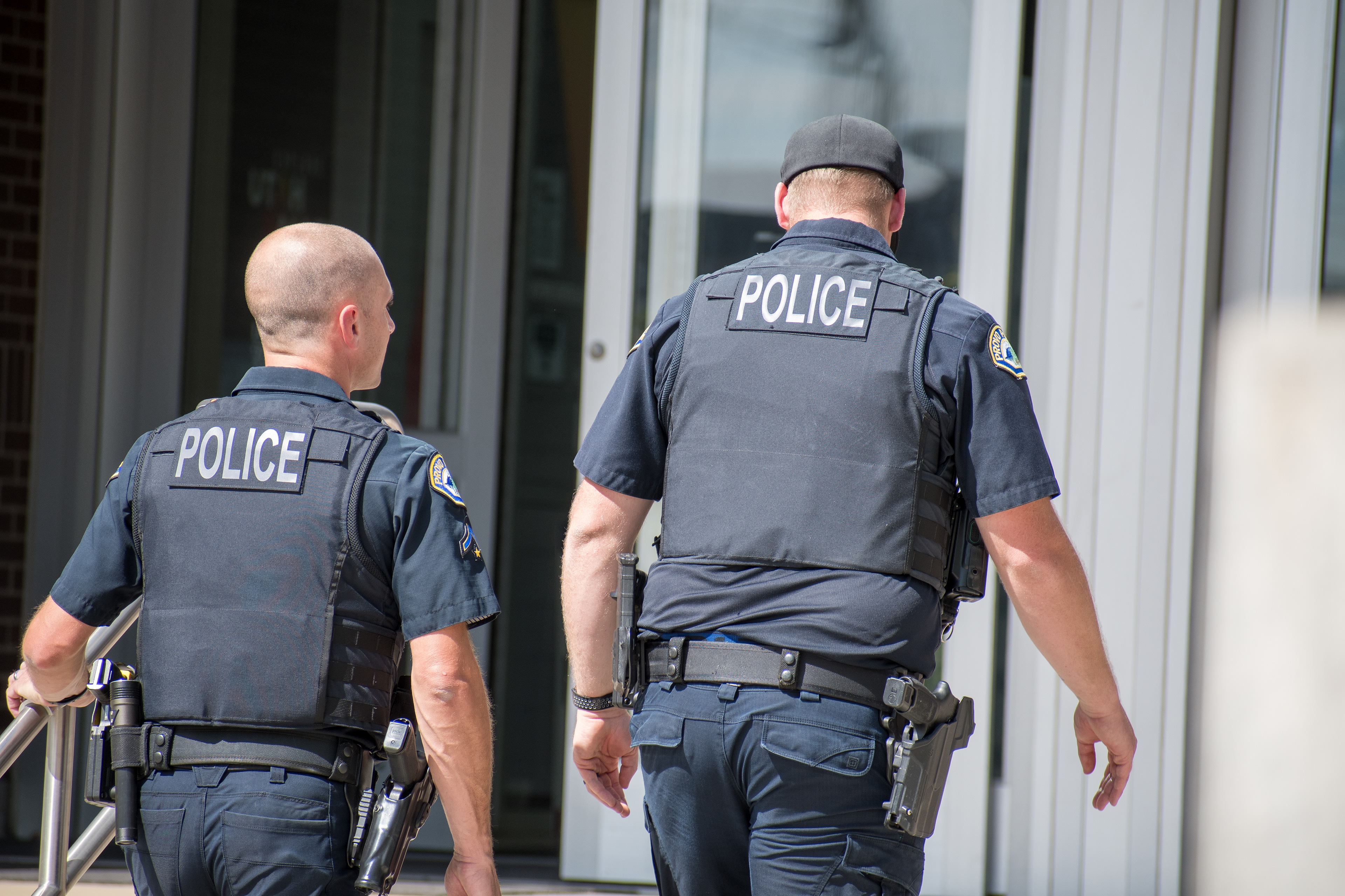 September 15, 2025 – Provo, Utah, United States: Two Provo Police Department officers walk toward the entrance of the Utah Valley Convention Center during a Department of Homeland Security career expo focused on recruiting law enforcement and security personnel. Photograph by Charles‑McClintock Wilson / ZUMA Press Wire