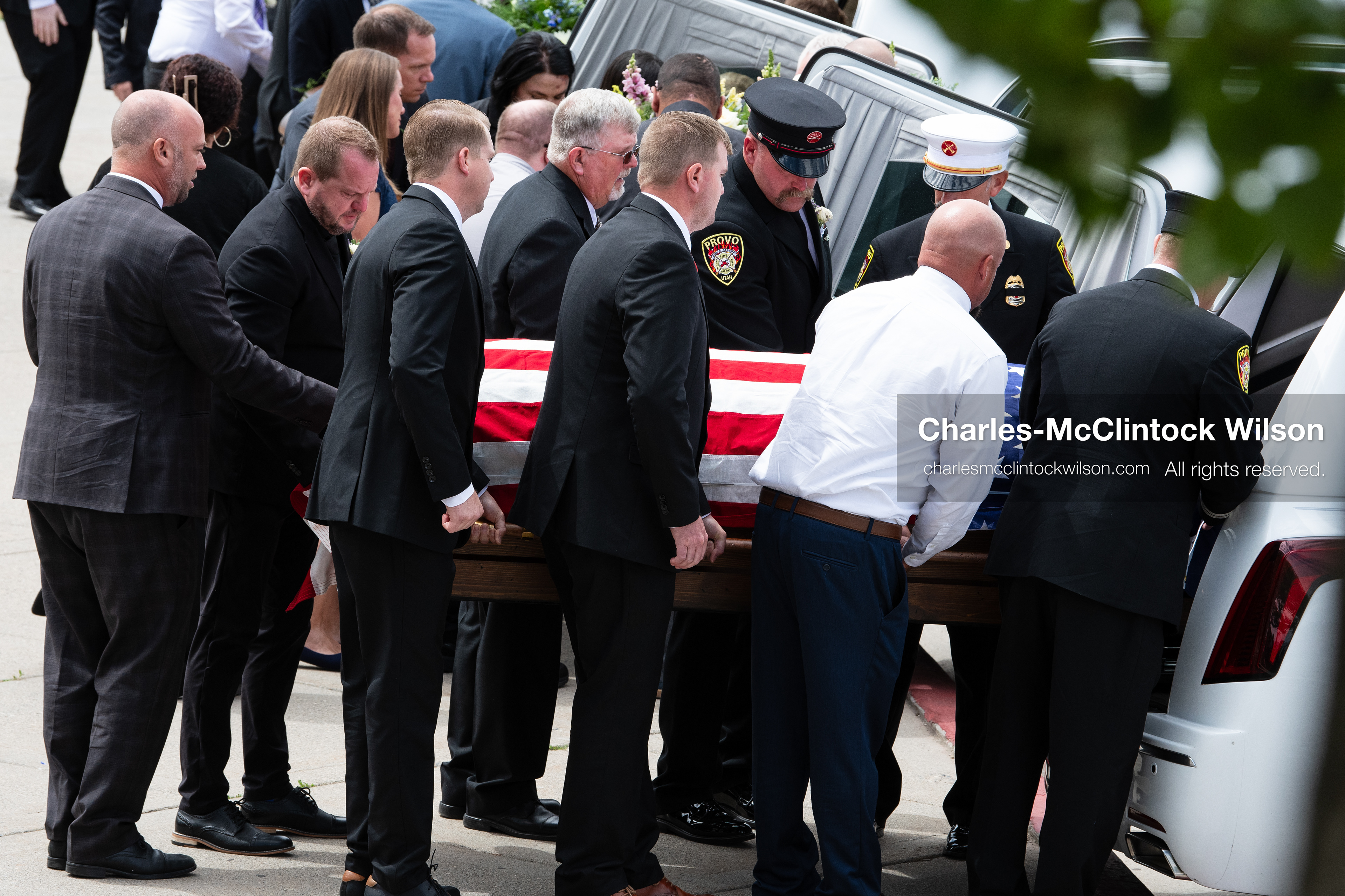Firefighters and pallbearers load the flag-draped casket of Provo Fire Captain Spencer Long into a white hearse outside the UCCU Center at Utah Valley University in Orem, Utah, on Wednesday, July 29, 2026. More than 300 people came to the public memorial ceremony to honor Captain Long, his wife Katrina, and three of their sons, who died after a flash flood hit their campsite near the Sunglow Campground in Wayne County. (Photo by Charles-McClintock Wilson/Sipa USA)