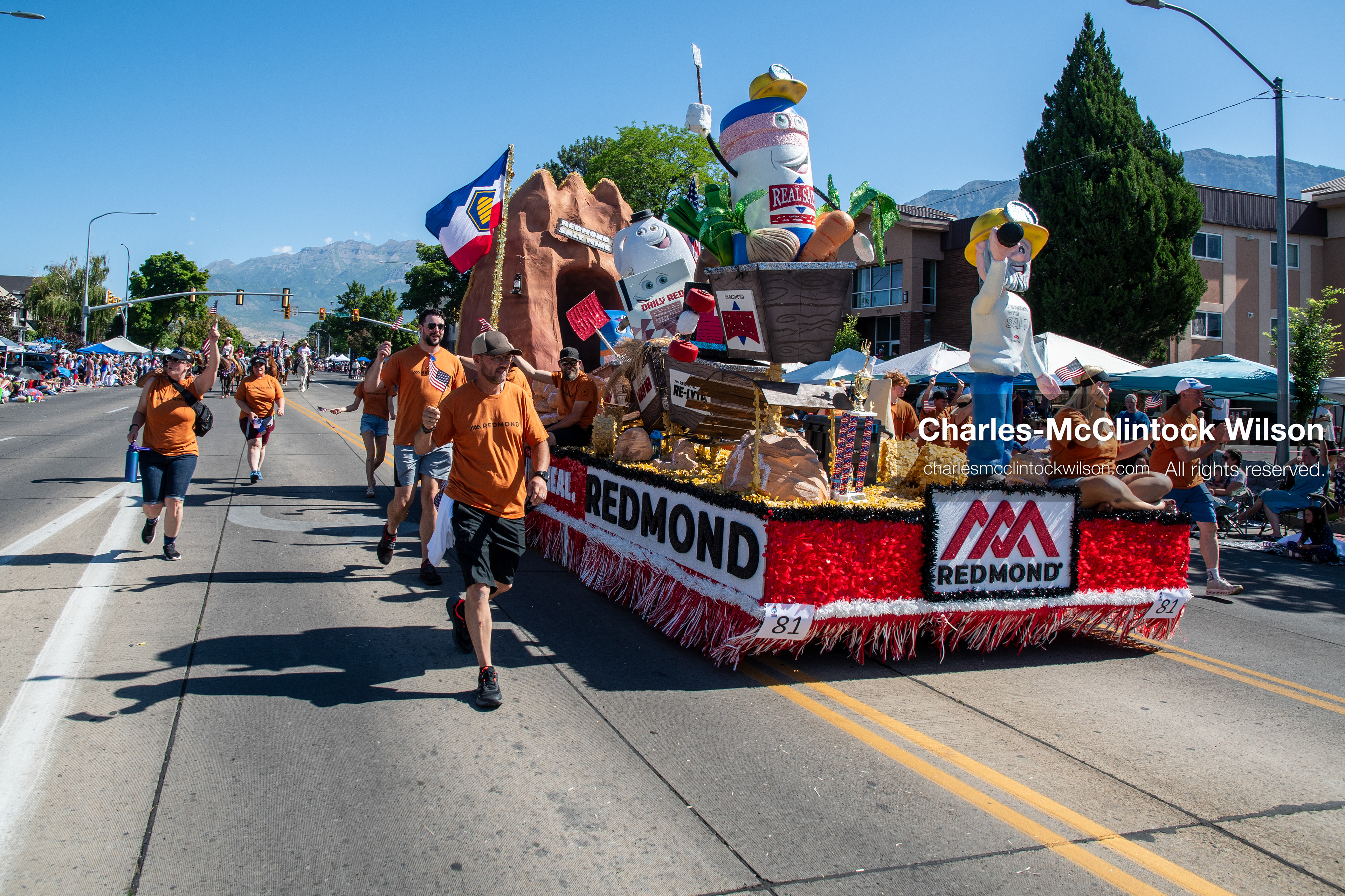 July 4, 2026, Provo, Utah, USA: A Redmond commercial parade float featuring brand mascots and walking participants in matching orange shirts moves along the route during America's Freedom Festival Grand Parade in Provo, Utah, Saturday, July 4, 2026. The annual Independence Day event features expanded programming to honor the 250th anniversary of United States independence. (Credit Image: © Charles-McClintock Wilson/ZUMA Press Wire)