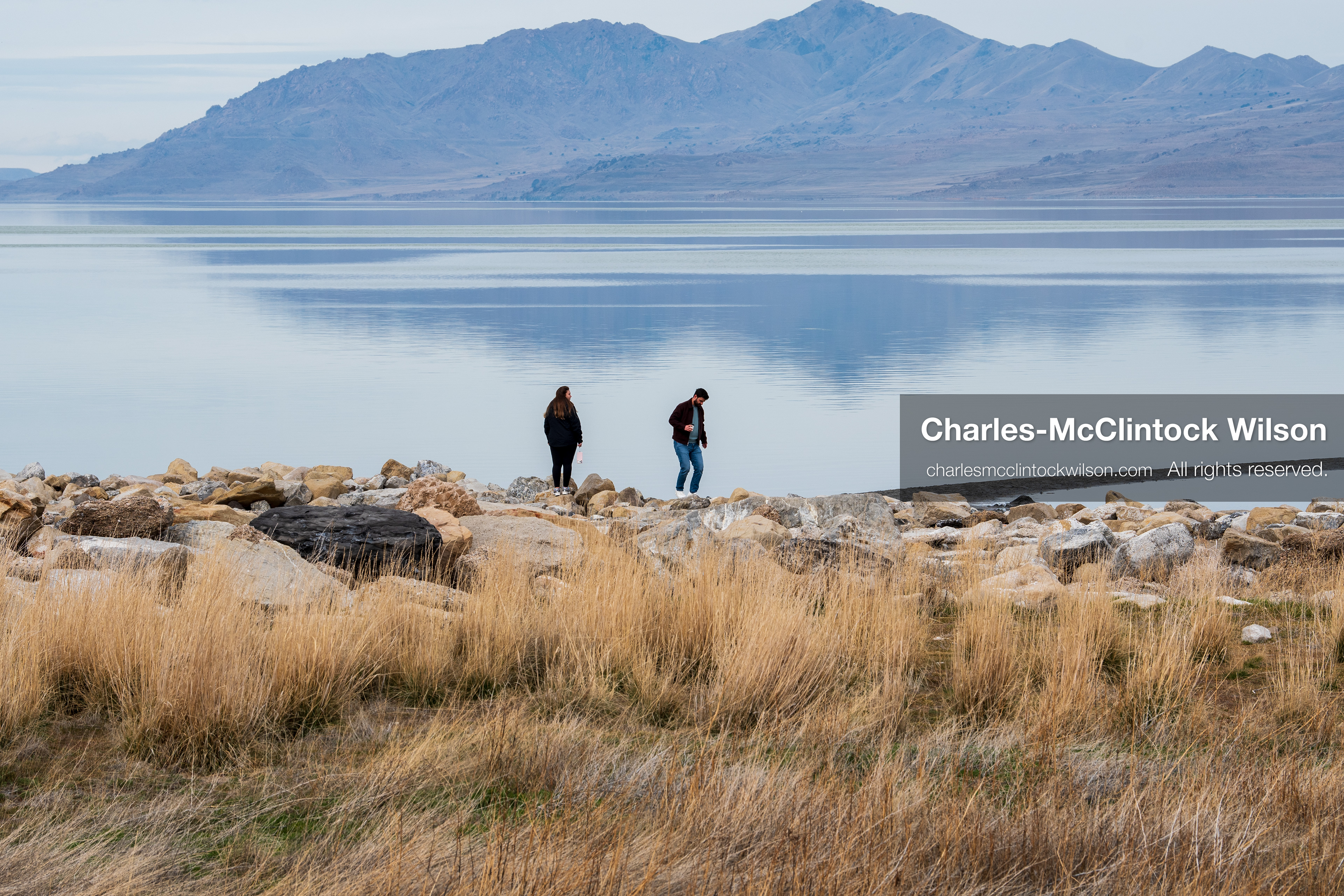 March 1, 2026, Great Salt Lake, Utah, USA: People walk along a narrow stretch of shoreline at the Great Salt Lake as water levels remain historically low. Reports from state officials and the Great Salt Lake Strike Team state that the lake continues to fall within a serious adverse‑effects range, with elevations among the lowest recorded in more than one hundred years. The lake has drawn increased public attention as lawmakers consider large‑scale water projects and long‑term plans to address declining conditions. (Credit Image: © Charles‑McClintock Wilson/ZUMA Press Wire)